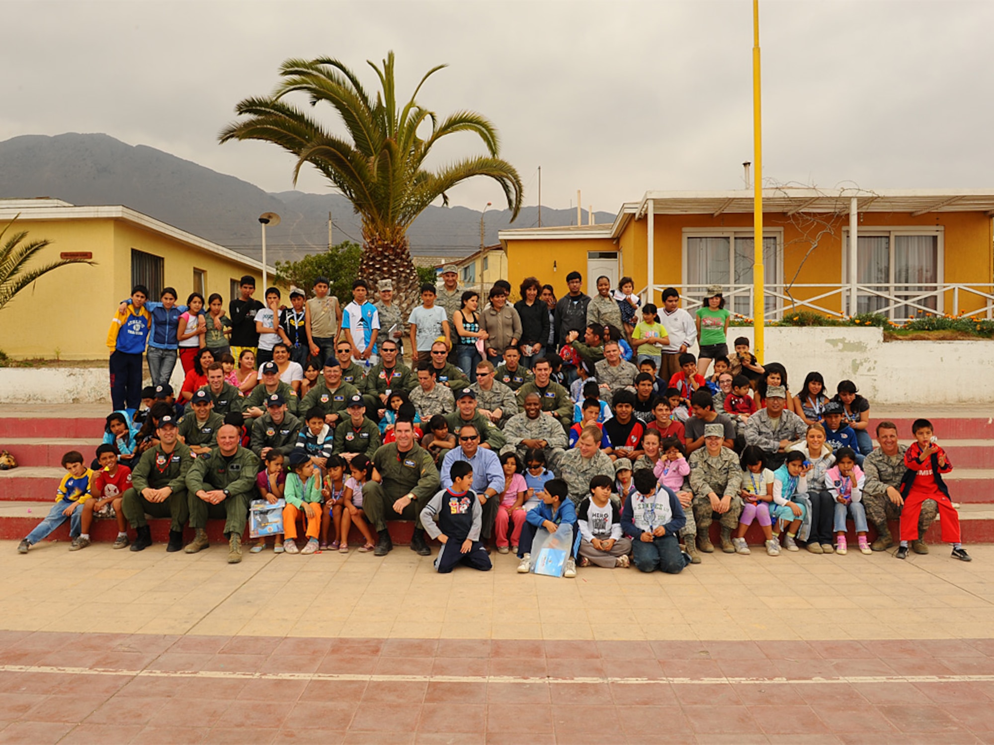 Airmen pose with children at the Aldeas SOS orphanage after visiting the home in Antofagasta, Chile for several hours on Sunday.  The Airmen were part of a more than 40 person team of US, Chilean and Argentine Air Force members who visited the home for orphaned and abandoned children while taking time off from exercise SALITRE, a five-nation event focused on coalition interoperability during peacekeeping operations. (U.S. Air Force photo by Master Sgt. Daniel Farrell)