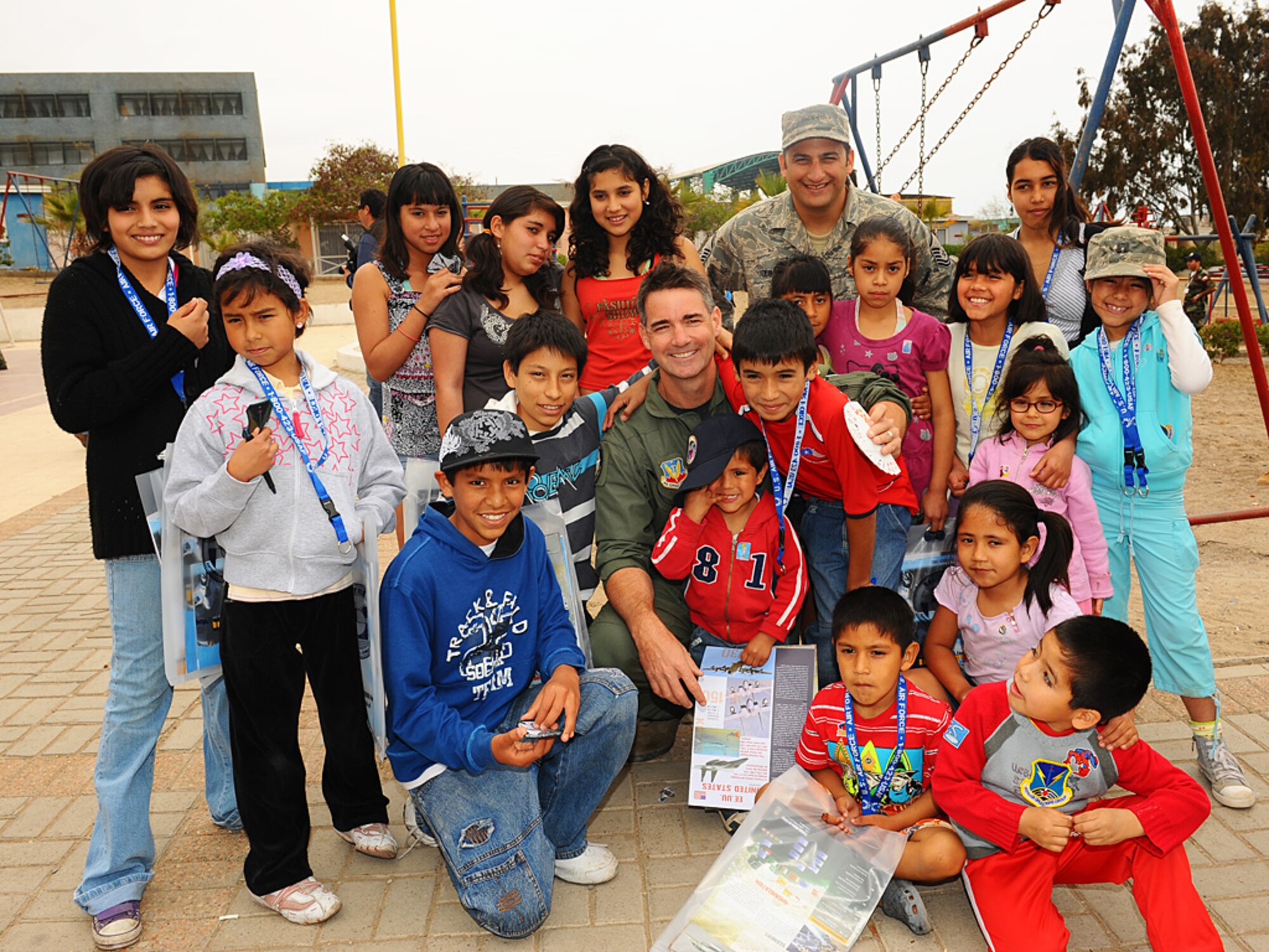 Col Roy Qualls, 159th Fighter Wing commander, and Master Sgt. David Quintero, an aircraft armament systems craftsman with the Louisiana Air National Guard pose with their new friends at the Aldeas SOS orphanage in Antofagasta, Chile.  The Airmen were part of a more than 40 person team of US, Chilean and Argentine Air Force members who visited the home for orphaned and abandoned children while taking time off from exercise SALITRE, a five-nation event focused on coalition interoperability during peacekeeping operations. (U.S. Air Force photo by Master Sgt. Daniel Farrell)