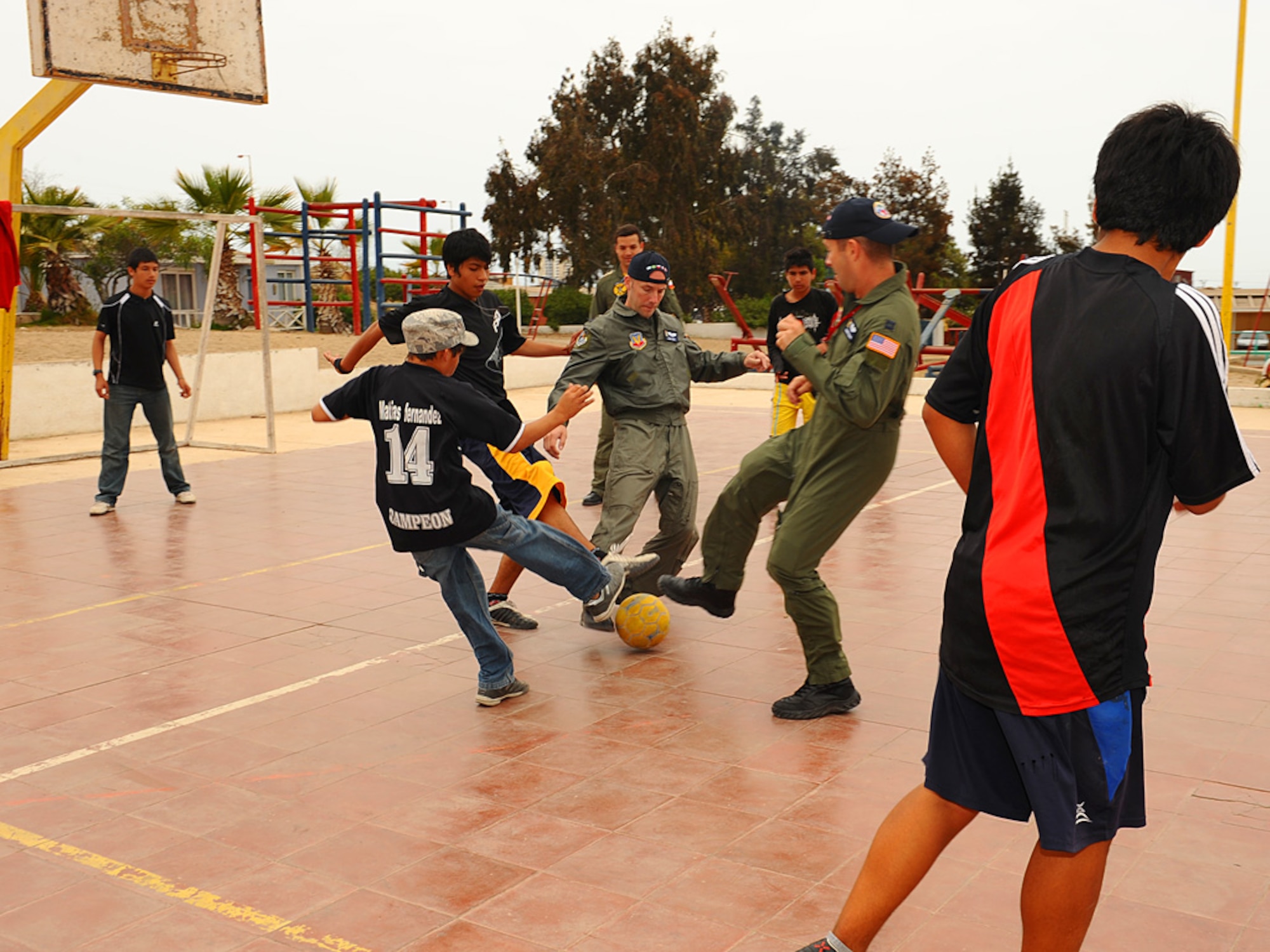 Members of the 71st Rescue Squadron play soccer with children at the Aldeas SOS orphanage in Antofagasta, Chile on Sunday.  The aircrew was part of a more than 40 person team of US, Chilean and Argentine Air Force members who visited the home for orphaned and abandoned children while taking time off from exercise SALITRE, a five-nation event focused on coalition interoperability during peacekeeping operations. (U.S. Air Force photo by Master Sgt. Daniel Farrell)