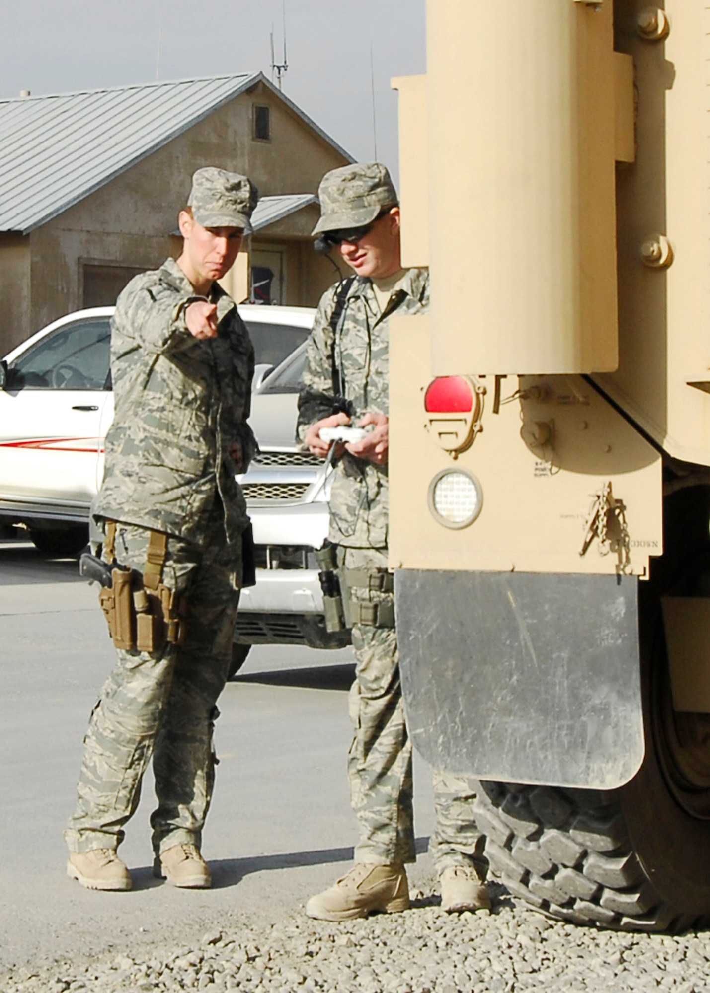 Staff Sgt. Elizabeth Spradley (left) gives directions to Senior Airman James Dobrynski, both explosive ordnance disposal technicians at Bagram Airfield, Afghanistan, during training Oct. 26, 2009. EOD teams use robots during missions to move or disarm improvised explosive devices and look for additional IEDs. They are joint expeditionary tasked Airmen attached to the 741st EOD Battalion. Sergeant Spradley, an Albuquerque, N.M., native, is deployed from Spangdahlem Air Base, Germany. Airman Dobrynski is deployed from Luke Air Force Base, Ariz., and hails from St. Louis, Mo. (U.S. Air Force photo/Senior Airman Felicia Juenke) 