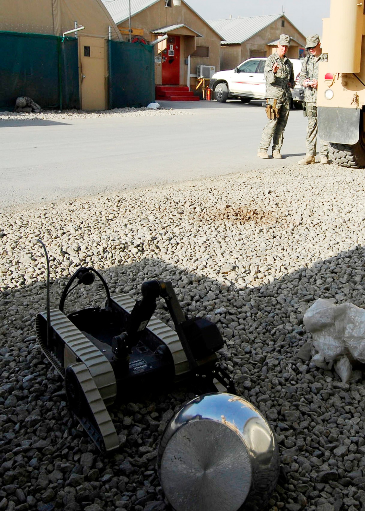 Staff Sgt. Elizabeth Spradley (left) and Senior Airman James Dobrynski, explosive ordnance disposal technicians at Bagram Airfield, Afghanistan, work together to have a robot pick up a mock improvised explosive device during training Oct. 26, 2009. The EOD Airmen are joint expeditionary tasked Airmen attached to the 741st EOD Battalion. Sergeant Spradley, an Albuquerque, N.M., native, is deployed from Spangdahlem Air Base, Germany.  Airman Dobrynski is deployed from Luke Air Force Base, Ariz., and hails from St. Louis, Mo. (U.S. Air Force photo/Senior Airman Felicia Juenke) 