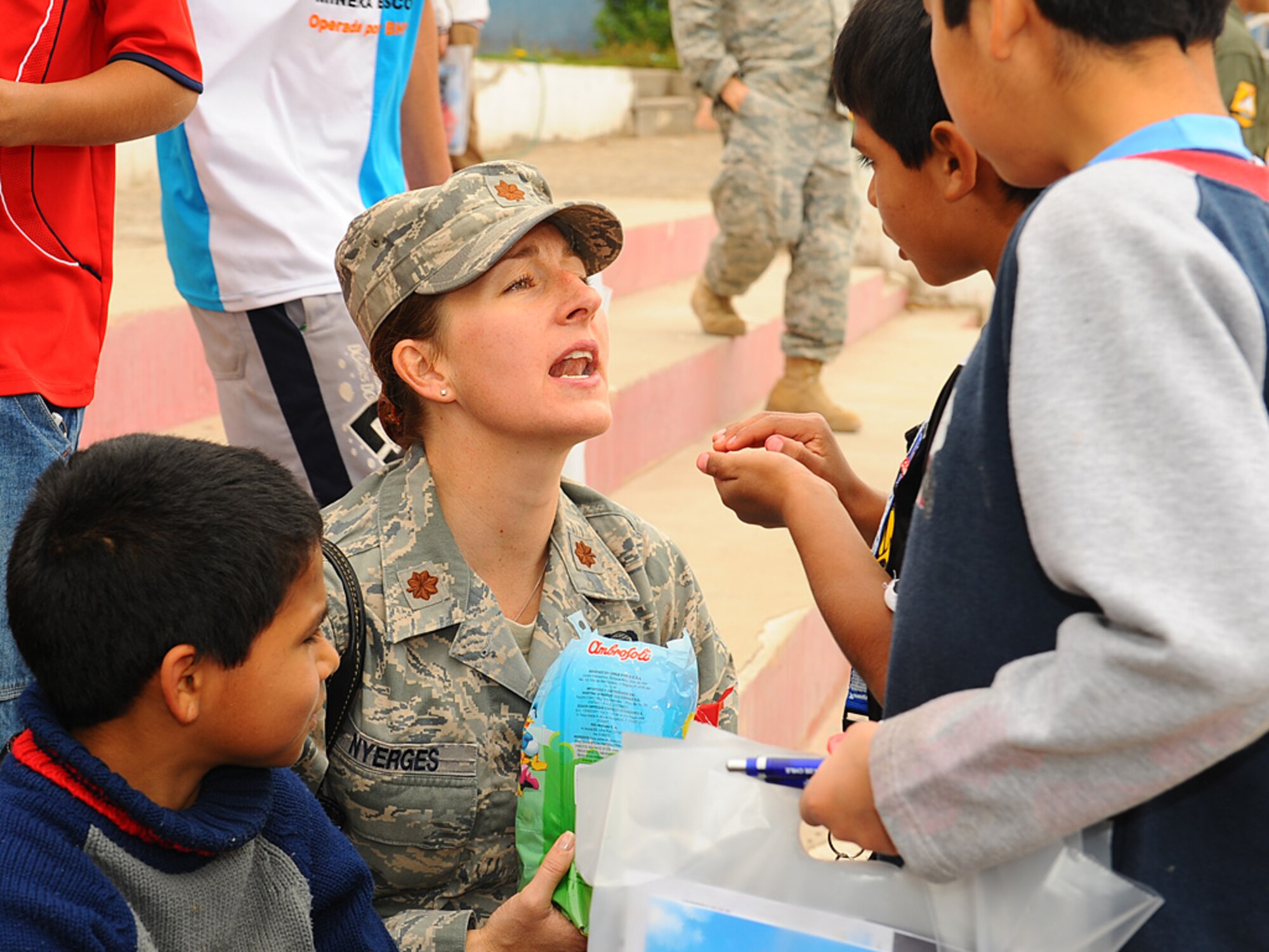 Maj. Jana Nyerges, a member of Air Forces Southern participating in exercise SALITRE, teaches English words to children at the Aldeas SOS orphanage during a visit to the center on Sunday.  More than 40 Airmen from the US Air Force, as well as, members of the Chilean and Argentine Air Forces, visited the home for orphaned and abandoned children in Antofagasta, Chile to donate items to the organization and provide an afternoon of fun and games to residents. (U.S. Air Force photo by Master Sgt. Daniel Farrell)