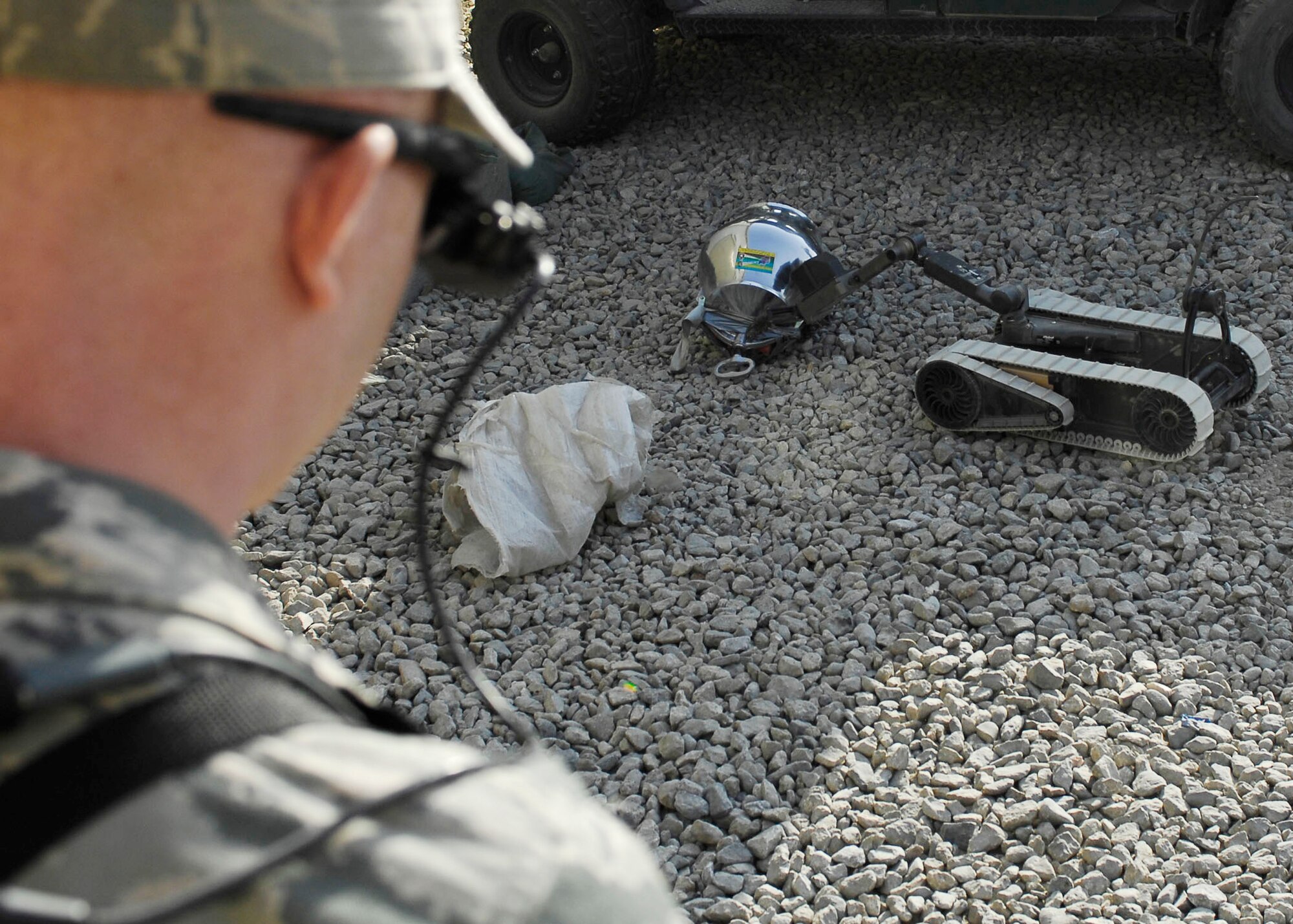 Senior Airman James Dobrynski, an explosive ordnance disposal technician at Bagram Airfield, Afghanistan, maneuvers a robot to disarm a mock improvised explosive device during training Oct. 26, 2009. The robots can be used during missions to move or disarm IEDs and look for additional IEDs. Airman Dobrynski is a joint expeditionary tasked Airman attached to the 741st EOD Battalion. He is deployed from Luke Air Force Base, Ariz., and hails from St. Louis, Mo. (U.S. Air Force photo/Senior Airman Felicia Juenke)