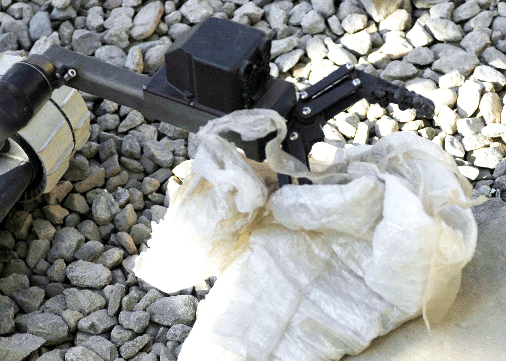 A robot is used to remove plastic around a mock improvised explosive device during training Oct. 26, 2009, at Bagram Airfield, Afghanistan. The robots are used by explosive ordnance disposal teams to assure maximum safety is taken when dealing with IEDs. (U.S. Air Force photo/Senior Airman Felicia Juenke) 