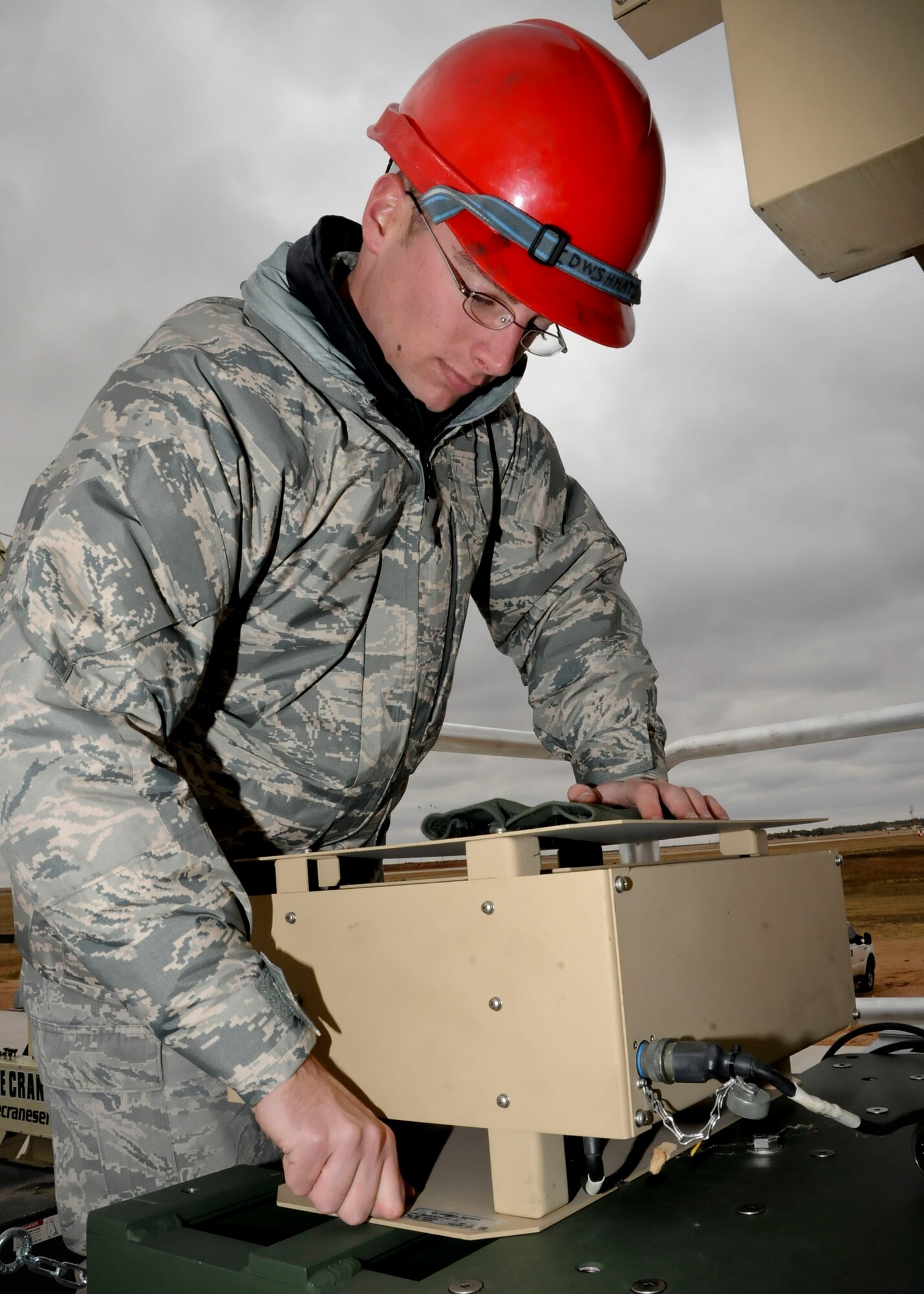 CANNON AIR FORCE BASE, N.M. -- Senior Airman Travis Wannarka, 27th Special Operations Aircraft Maintenance Squadron, tightens a bolt on a power supply for a ground data terminal antenna here, Oct. 26. The power supply given off to the GDT is roughly 110 volts and has a backup of a 24 volt battery. (U.S. Air Force photo/ Senior Airman Erik Cardenas)