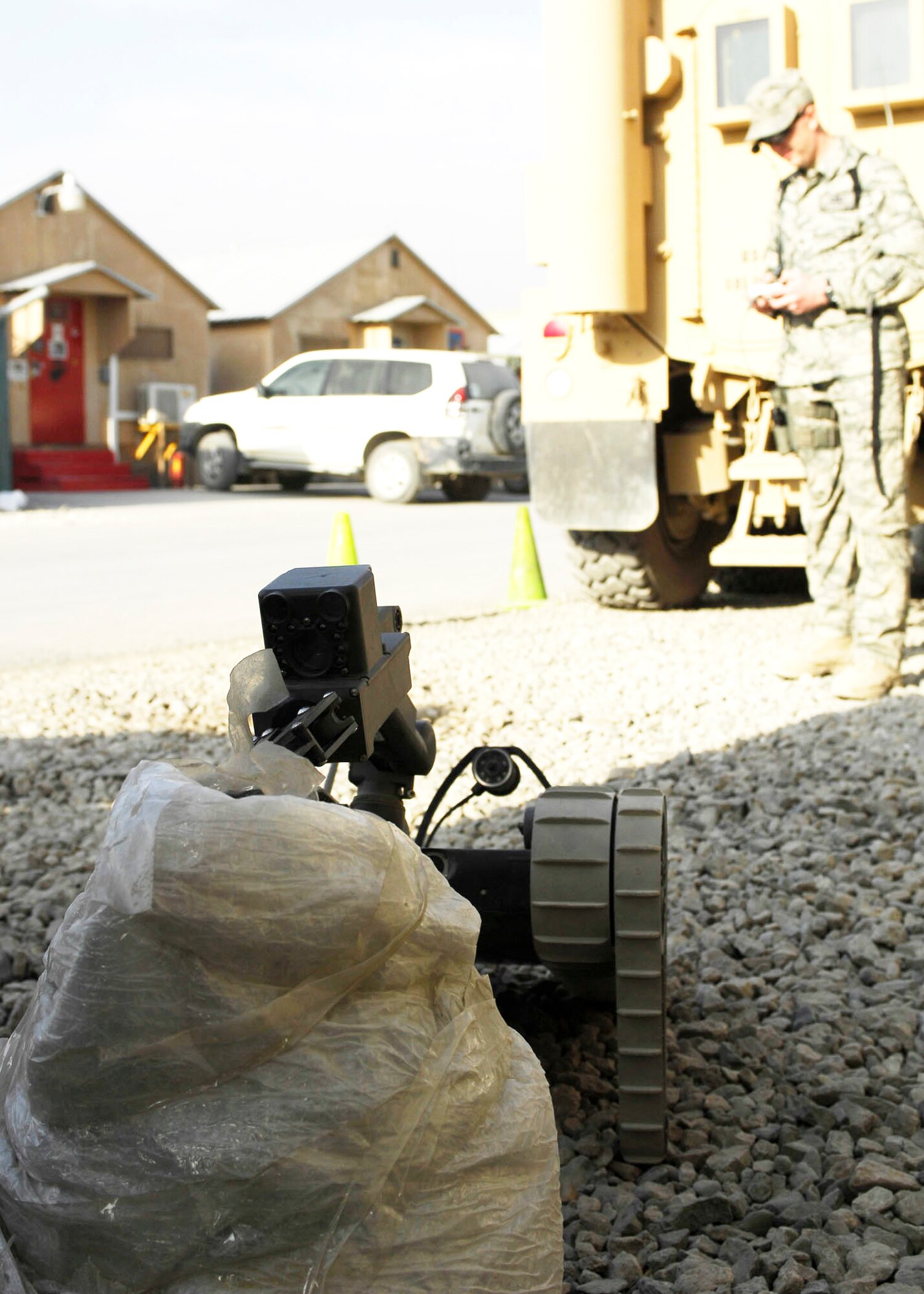 Senior Airman James Dobrynski, an explosive ordnance disposal technician at Bagram Airfield, Afghanistan, maneuvers a robot during training Oct. 26, 2009. The robot is being used to remove plastic around a mock improvised explosive device. Airman Dobrynski is a joint expeditionary tasked Airman to the 741st EOD Battalion. He is deployed from Luke Air Force Base, Ariz., and hails from St. Louis, Mo. (U.S. Air Force photo/Senior Airman Felicia Juenke)