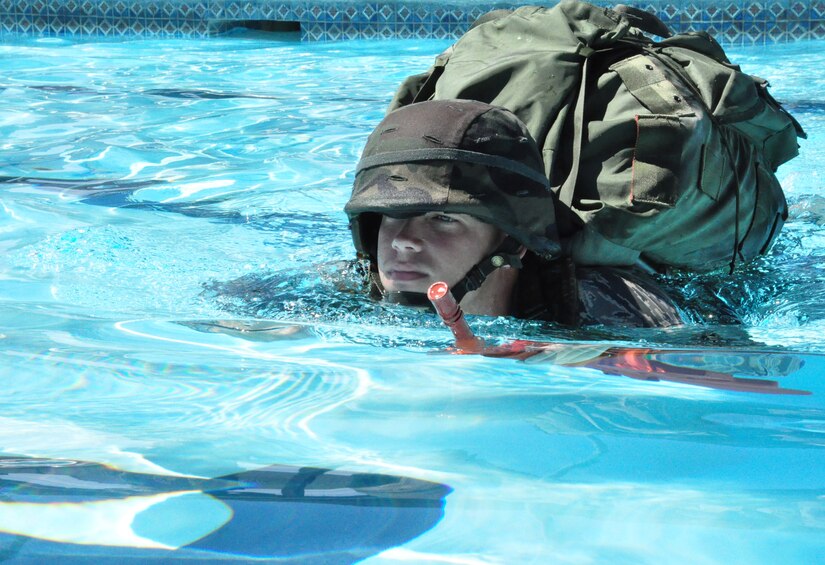 Air Force Staff Sgt. Brian Peters practices using a travel stroke to swim distance with full equipment on during Water Survival Training at the Soto Cano Air Base swimming pool Thursday, Oct. 22, 2009. Sergeant Peters and 13 other personnel recovery team members trained on a variety of water-based tactics to prepare them to operate safely in rescue and recovery missions. (U.S. Air Force photo/Tech. Sgt. Mike Hammond)