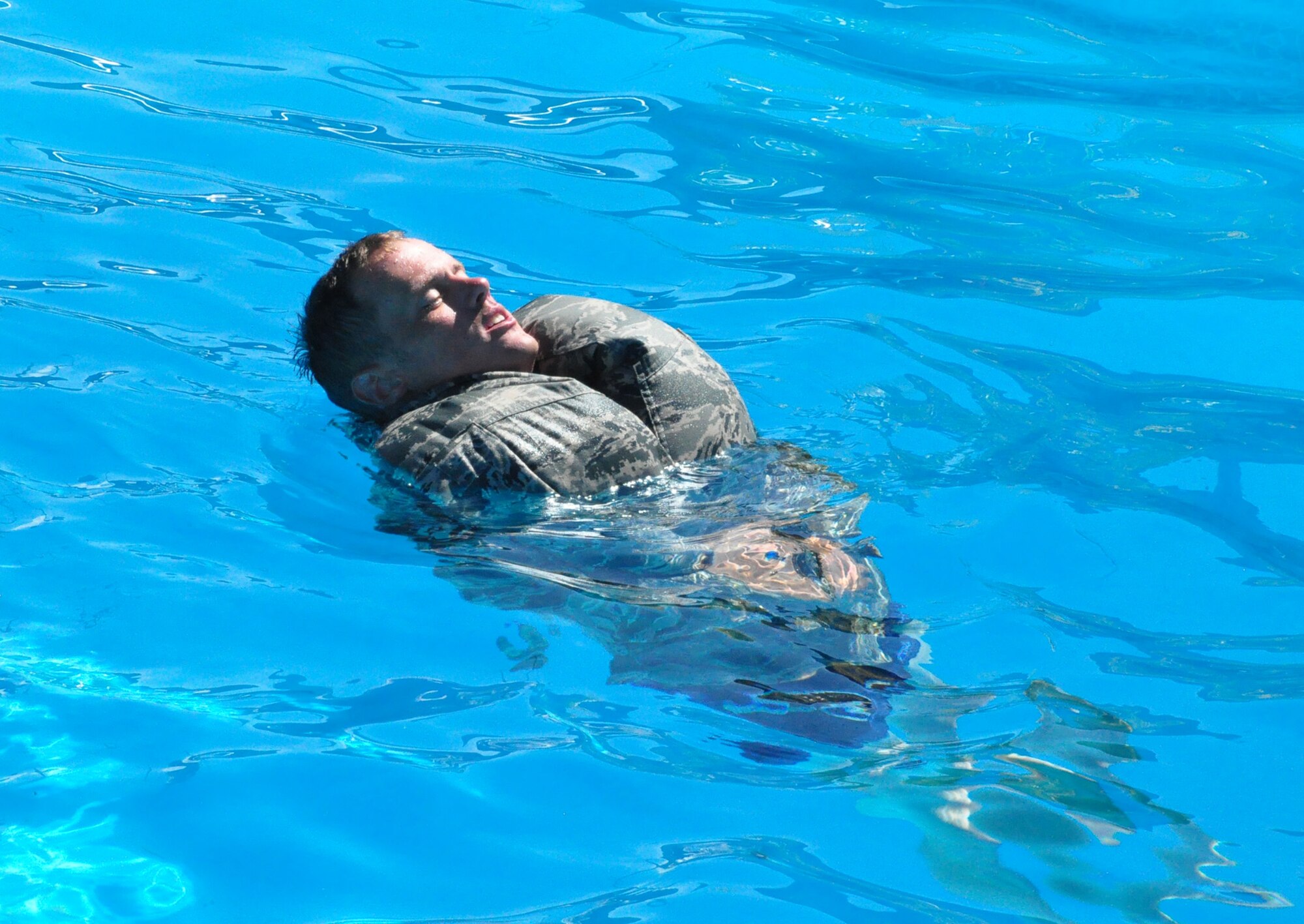 Air Force Tech. Sgt. Brent McCoy uses his Airman Battle Uniform trousers as a floatation device during Water Survival Training at the Soto Cano Air Base swimming pool Thursday, Oct. 22, 2009. Sergeant McCoy and 13 other personnel recovery team members trained on a variety of water-based tactics to prepare them to operate safely in rescue and recovery missions. (U.S. Air Force photo/Tech. Sgt. Mike Hammond)