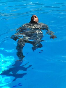 Air Force Senior Airman Christopher Newberry practices floating and treading water in uniform during Water Survival Training at the Soto Cano Air Base swimming pool Thursday, Oct. 22, 2009. Airman Newberry was one of 14 personnel recovery team members receiving training on a variety of water-based tactics to prepare them to operate safely in rescue and recovery missions. (U.S. Air Force photo/Tech. Sgt. Mike Hammond)