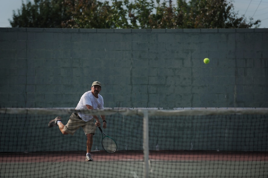 MOODY AIR FORCE BASE, Ga. -- Anthony Cuellar, 38th Rescue Squadron vehicle manager, runs to hit a tennis ball back to his opponent during a tennis match during the 23rd Wing Super Sports Day here Oct. 23. Throughout the day, units competed in numerous sporting events including tennis, softball, basketball and tug-of-war. (U.S. Air Force photo by Senior Airman Gina Chiaverotti-Paige)