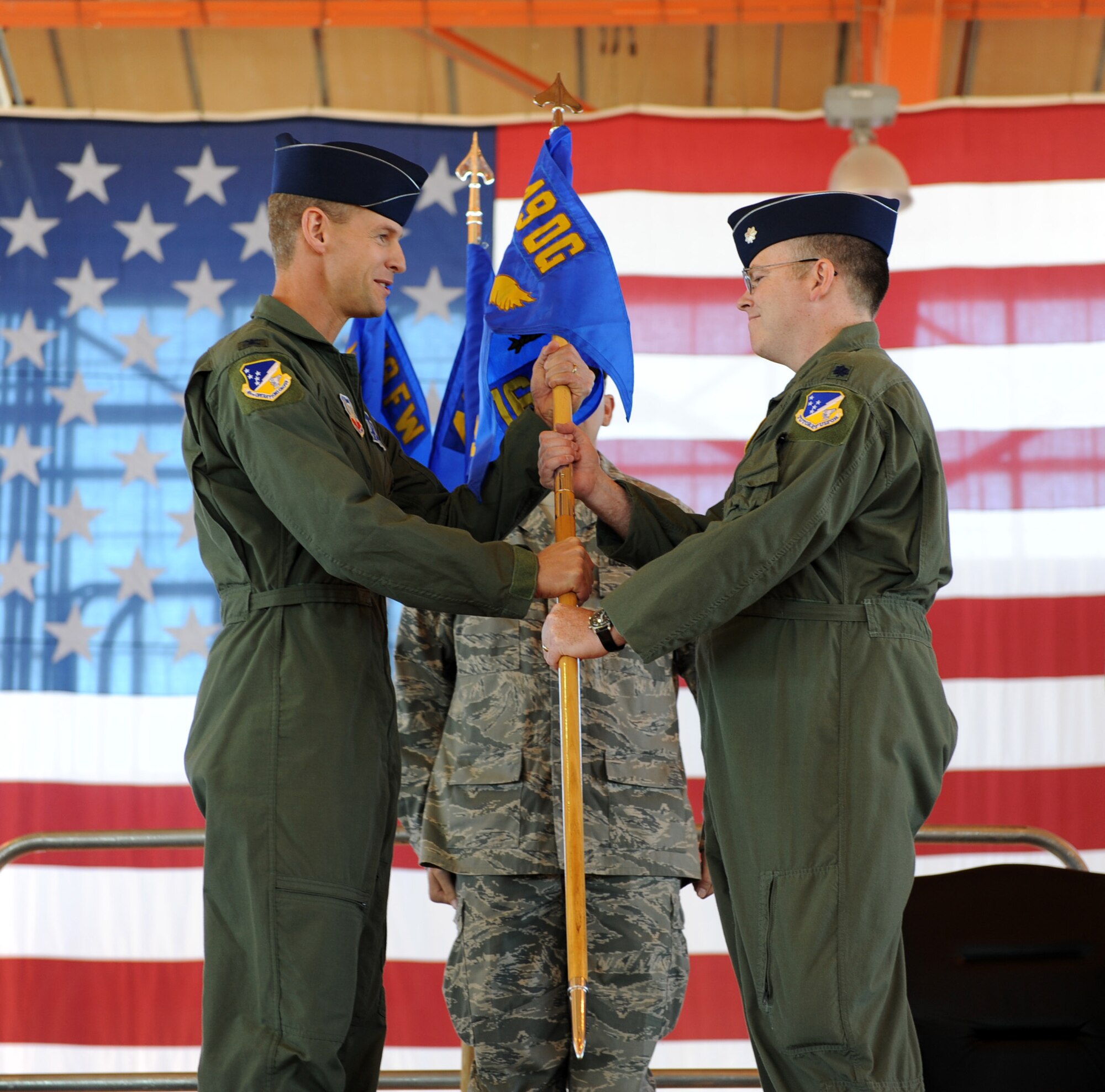 HOLLOMAN AIR FORCE BASE, N.M. -- Col. Michael Stapleton, 49th Operations Group commander, passes the 16th Training Squadron command guidon to Lt. Col. Peter Marsch during an assumption of command ceremony here Oct. 23. The 16th TRS was one of three remotely piloted vehicle training squadrons to stand up under the 49th Fighter Wing during the ceremony. (U.S. Air Force photo by Senior Airman John D. Strong II)
