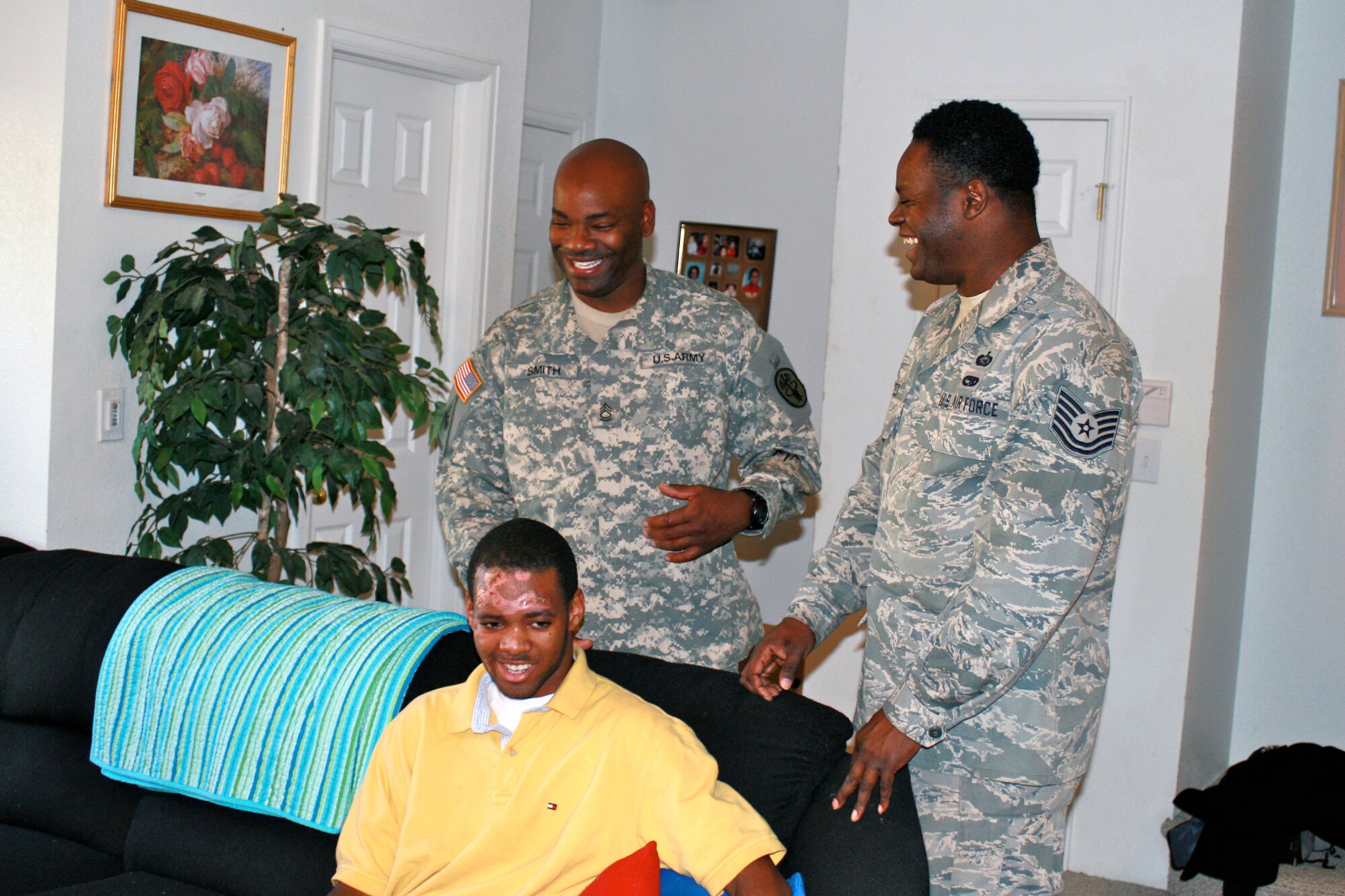Sergeant 1st Class Travion Smith, (left) stationed at Fort Carson, and Tech. Sgt. Rodney Reed, 21st Space Wing Equal Opportunity Office, talk with Jeremy Russeau, 18, of Colorado Springs, Oct. 22. Sergeants Smith and Reed found Mr. Russeau banged up, struck by a hit-and-run driver, in the middle of the road at Academy Boulevard and Chelton Road Oct.17. They called 911, covered him with a blanket and kept him from being hit by oncoming traffic while emergency crews responded. Jeremy, who is recovering from his injuries, wanted to thank the sergeants in person. (Photo by Stacie Shain) 