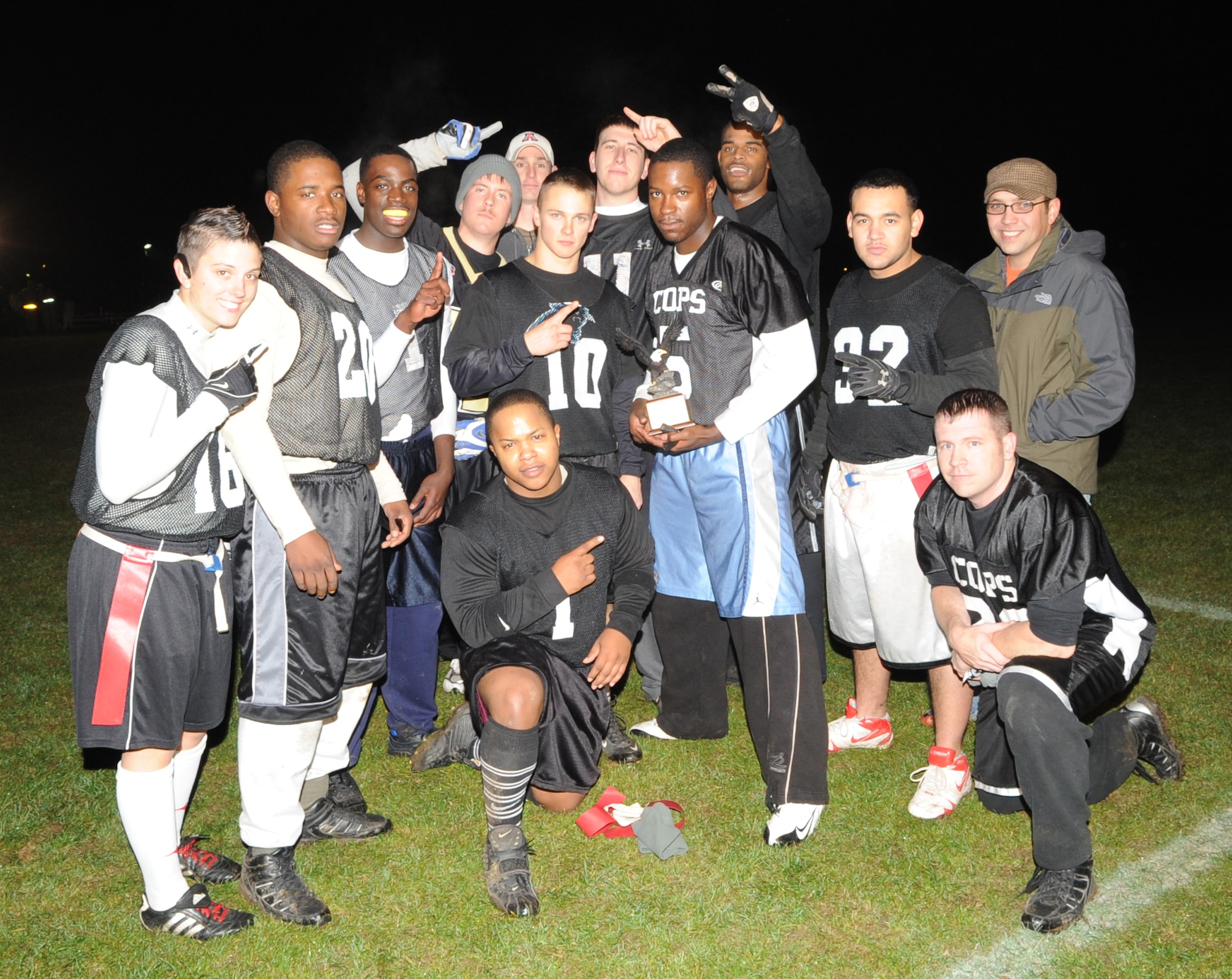 SPANGDAHLEM AIR  BASE, Germany -- Members from the 52nd Security Forces Squadron intramural flag football team celebrate after winning Spangdahlem's intramural flag football championship.  The 52nd SFS team defeated the 52nd Logistics Readiness Squadron team 15-14 in the fourth quarter to win the championship. Both teams are eligible to represent Spangdahlem Air Base for the U.S. Air Forces in Europe intramural flag football team championship at Camp Darby, Italy, Nov. 12-15.  (U.S. Air Force photo/Airman 1st Class Nick Wilson)