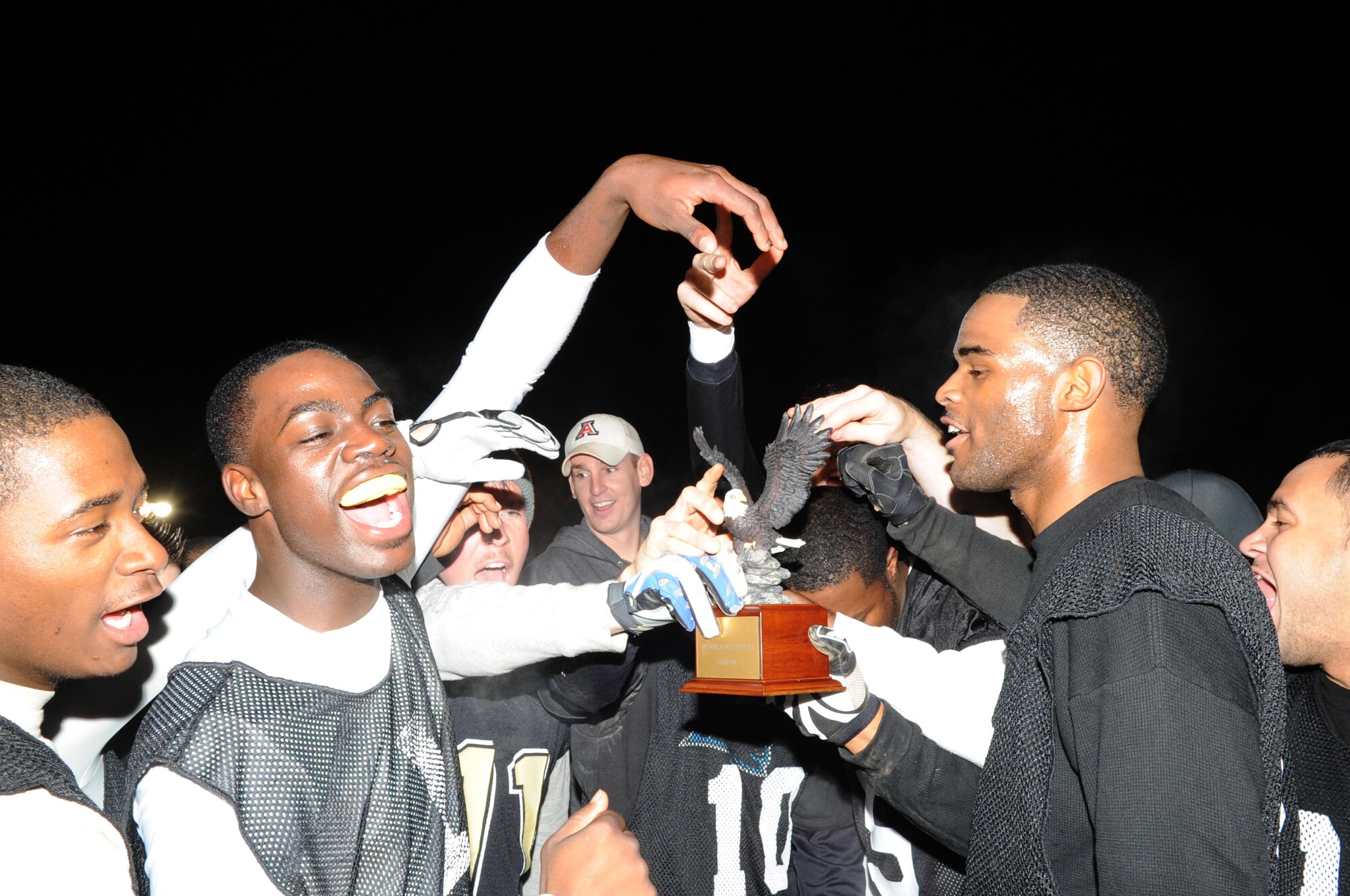 SPANGDAHLEM AIR  BASE, Germany -- Members from the 52nd Security Forces Squadron intramural flag football team celebrate after winning Spangdahlem's intramural flag football championship.  The 52nd SFS team defeated the 52nd Logistics Readiness Squadron team 15-14 in the fourth quarter to win the championship. Both teams are eligible to represent Spangdahlem Air Base for the U.S. Air Forces in Europe intramural flag football team championship at Camp Darby, Italy, Nov. 12-15.  (U.S. Air Force photo/Airman 1st Class Nick Wilson)