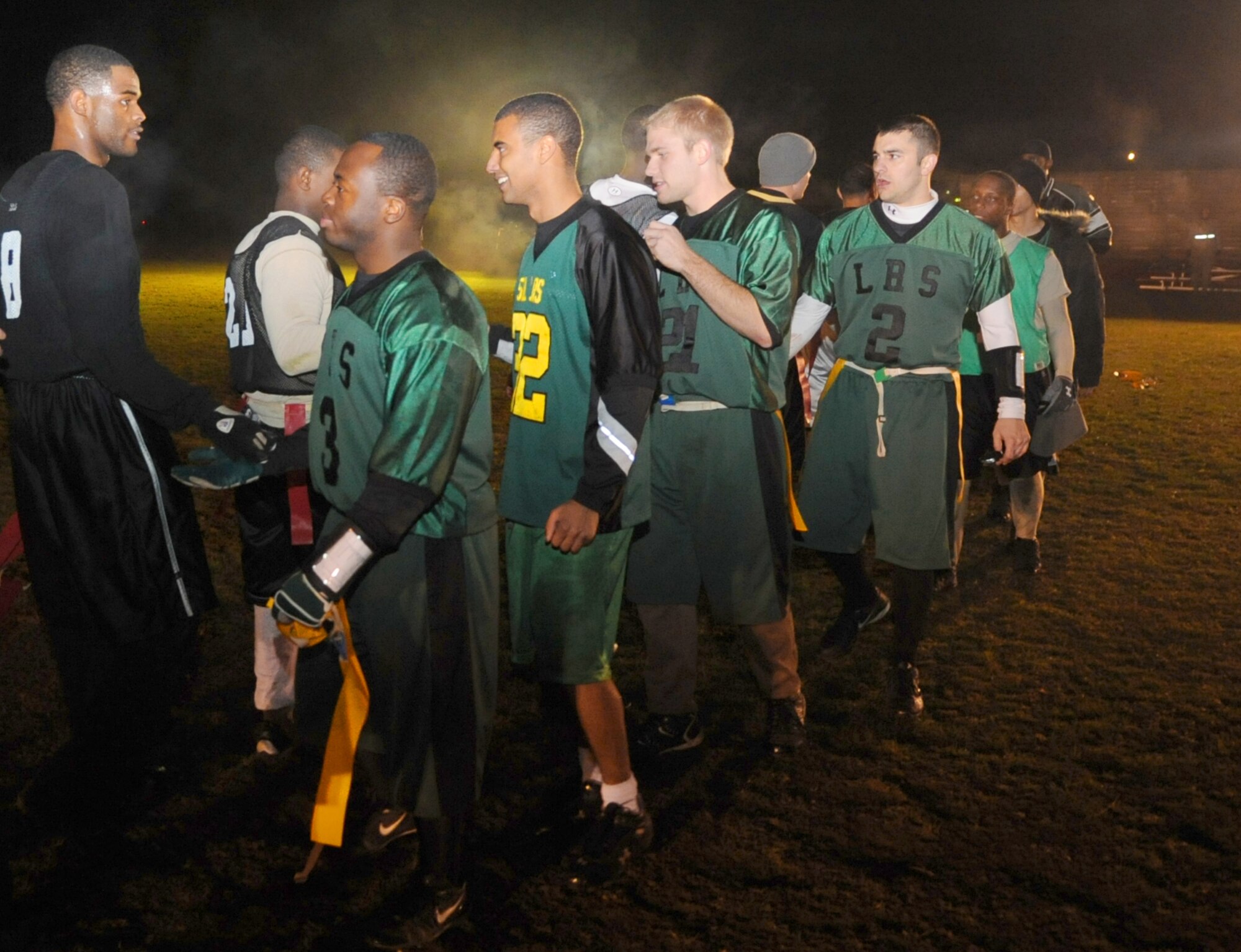 SPANGDAHLEM AIR  BASE, Germany -- Members from the 52nd Logistics Readiness Squadron intramural flag football team (green jerseys) congratulate members of the 52nd Security Forces Squadron intramural flag football team (black jerseys) after playing the intramural flag football championship.  The 52nd SFS team defeated the 52nd LRS team 15-14 in the fourth quarter to win the championship. Both teams are eligible to represent Spangdahlem Air Base for the U.S. Air Forces in Europe intramural flag football team championship at Camp Darby, Italy, Nov. 12-15.  (U.S. Air Force photo/Airman 1st Class Nick Wilson)