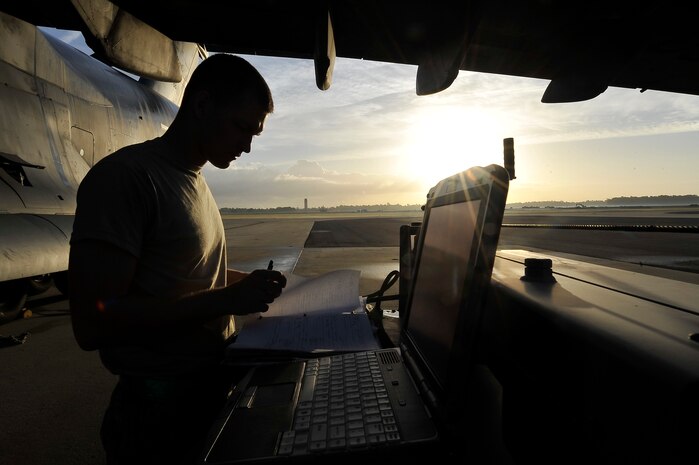 Airman 1st Class Todd Elkins looks up C-17 discrepancy information in an aircraft maintenance records binder on the Charleston AFB flightline Oct. 23. Maintenance technicians at Charleston AFB work around the clock every day to keep the 437th and 315th Airlift Wings' fleet of C-17s flying. Airman Elkins is an electrical and environmental systems journeyman with the 437th Aircraft Maintenance Squadron. (U.S. Air Force photo/James Bowman)