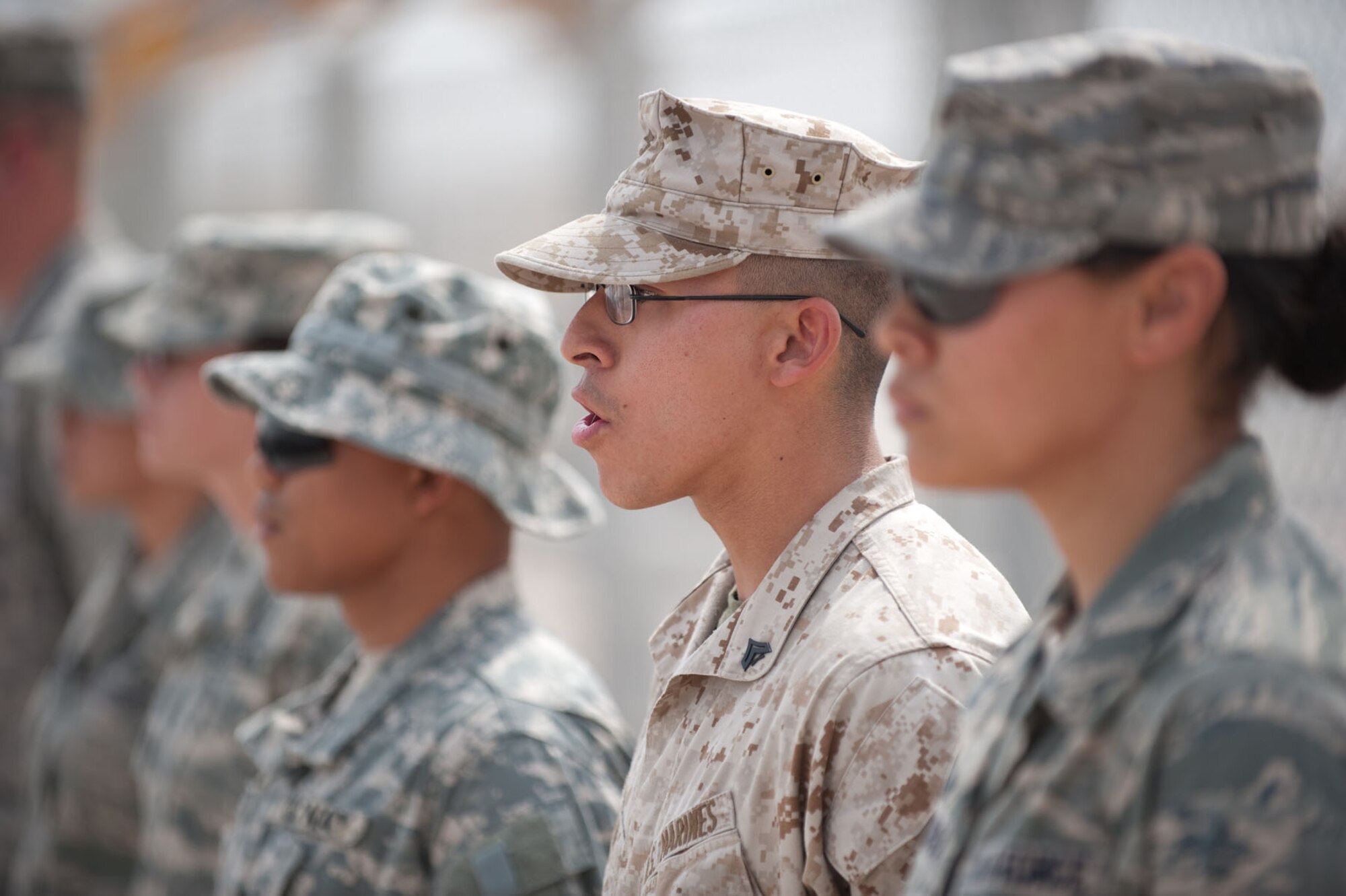 U.S. Marine Corps Cpl. Dennis Jiron recites the 5th article of the U.S. Military Code of Conduct during a POW/MIA memorial run, Oct. 24, 2009, in Southwest Asia. More than 200 military servicemembers ran, interchangeably, for 24 hours around a half-mile course, continuously carrying the POW/MIA flag to help raise awareness as well as more than $700 for the POW/MIA Combined Federal Campaign charity. (U.S. Air Force photo/Staff Sgt. Robert Barney) 