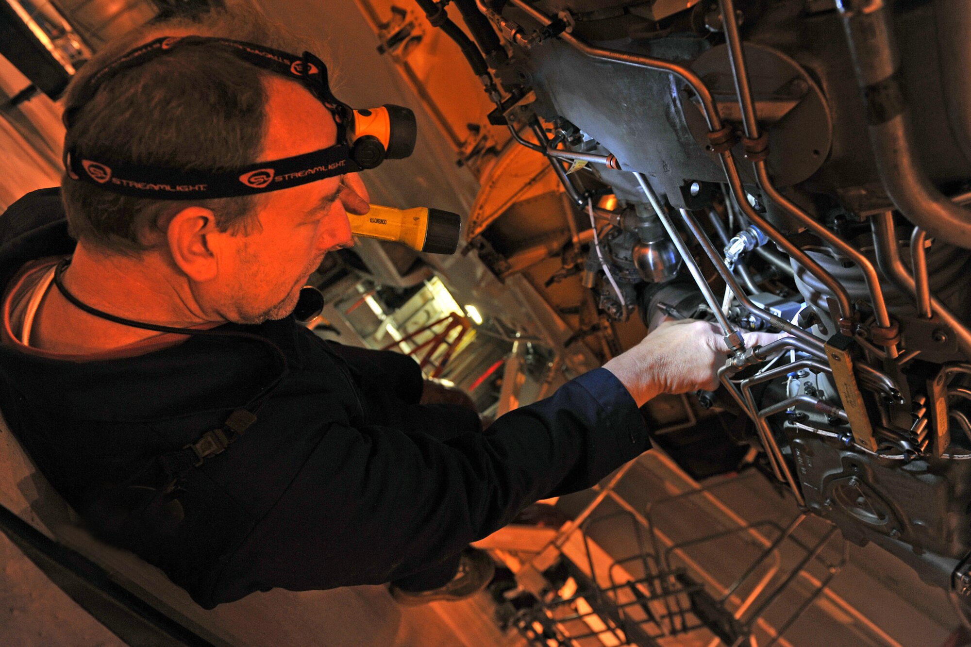 OFFUTT AIR FORCE BASE, Neb., -- Robert Finch, an aircraft mechanic with the 55th Maintenance Squadron isochronal phased inspection dock, inspects the engine lines of an RC-135 aircraft, during an isochronal inspection at the Bennie Davis Maintenance Facility here Oct. 23. In the isochronal phase inspection dock, approximately 40 people are responsible for ensuring Offutt's 135's are mission ready. The 55th Wing was recently awarded the Meritorious Unit Award, an honor that recognizes exceptionally meritorious conduct in the performance of outstanding achievement or service, in direct support of combat operations for at least 90 continuous days. U.S. Air Force Photo by Charles Haymond