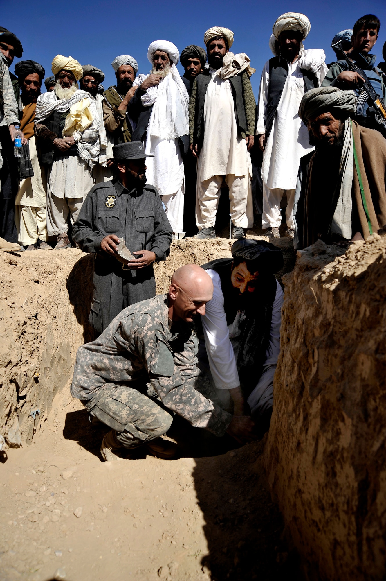 Lt. Col. Andy Veres places one of the first rocks at a ground-breaking ceremony with Zabul's Provincial Governor Muhammad Ashraf Naseri Oct. 22, 2009, at Shajoy, Afghanistan. The placing of the rock symbolizes the beginning of constructions for the first high school in the province dedicated to educating females. Colonel Veres is the commander of the Zabul Provincial Reconstruction Team. (U.S. Air Force photo/Staff Sgt. Angelita Lawrence)