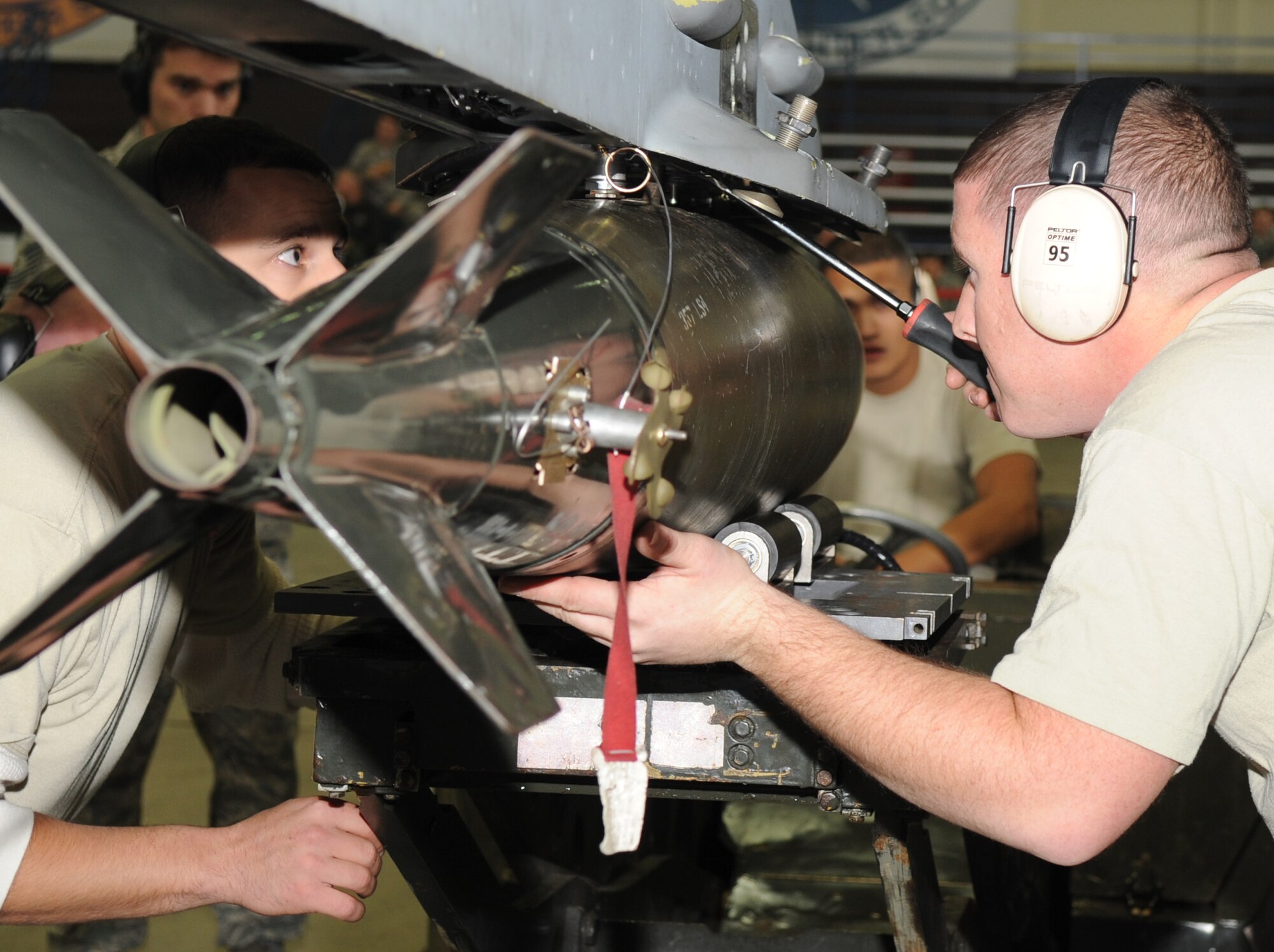 SPANGDAHLEM AIR BASE, Germany – Members from the 22nd Fighter Squadron load a weapon onto an F-16 Fighting Falcon during the third quarter Weapons Load Crew Competition Oct. 23. The 22nd and 81st Fighter Squadrons put together three-man teams and competed against each other to load weapons onto the F-16 and the A-10 Thunderbolt II in the fastest time. The 81st FS won the third quarter competition. (U.S. Air Force photo/Airman 1st Class Staci Miller)