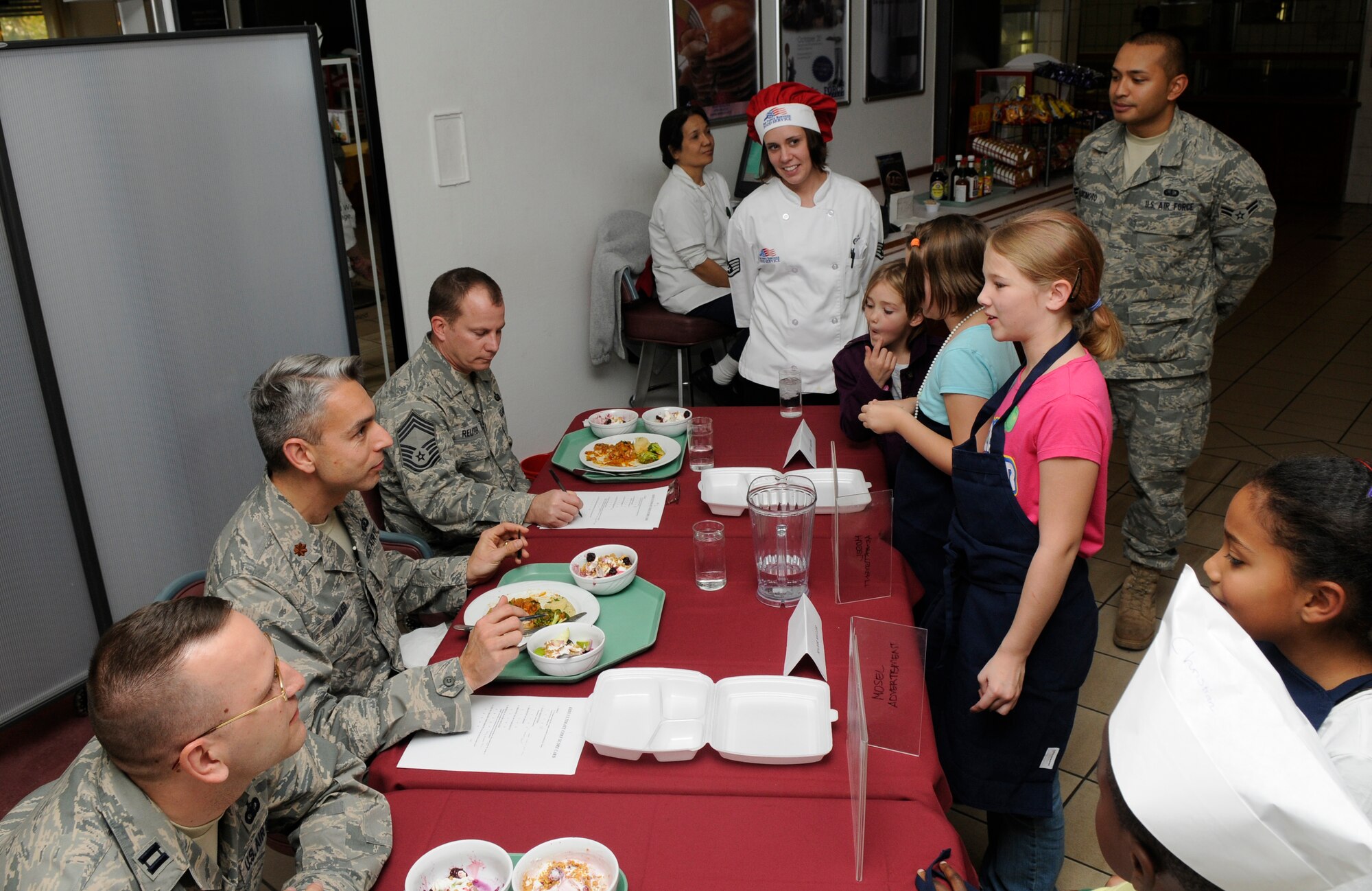 SPANGDAHLEM AIR BASE, Germany – The Kid’s Iron Chef Competition judges ask students from team one questions about their dish Oct. 20. Students from the Spangdahlem Middle School were split into three teams, and each team created a different dish to be judged. (U.S. Air Force photo/Airman 1st Class Staci Miller)