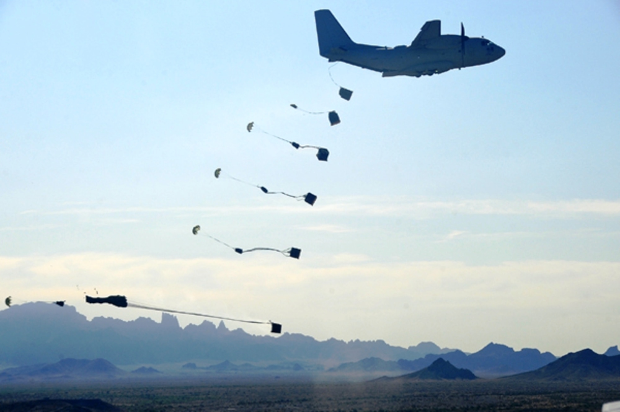 A C-27J Spartan practices airdropping bundles during flight testing of the plane at Yuma Proving Grounds, Ariz., in early 2009.  In April, through Resource Management Decision 802, Defense Secretary Robert Gates moved the C-27J program and its related direct support mission from the Army to the Air Force.  (U.S. Air Force Photo) 