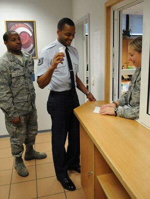 U.S. Air Force Tech. Sgt. James McKee, 2nd Air Postal Squadron resource advisor, brings a urine sample back to Staff Sgt. Holly Klug, 86th Medical Operations Squadron drug testing program administrator manager, while being observed by Staff Sgt. Demarkulus Menyfield, USAFE A6 frequency management, Ramstein Air Base, Germany, Oct. 26, 2009.  The Demand Reduction Drug Testing facility is located in the Southside Fitness Center on Ramstein and tests approximately 80 people during a normal test day. (U.S. Air Force photo by Airman 1st Class Caleb Pierce) 