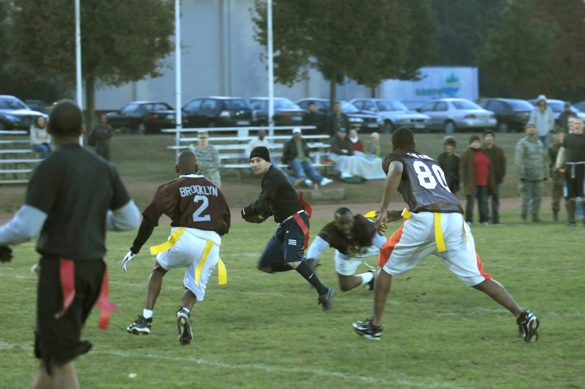 Team Comm running back Blane Woodard maneuvers around Team Landstuhl Regional Medical Center players on his way to the goal line during the Army versus Air Force flag football game, Vogelweh Military Complex, Germany, Oct. 21, 2009. The Air Force team beat the Army with a final score of 12-7. (U.S. Air Force photo by Tech. Sgt. Sean White)