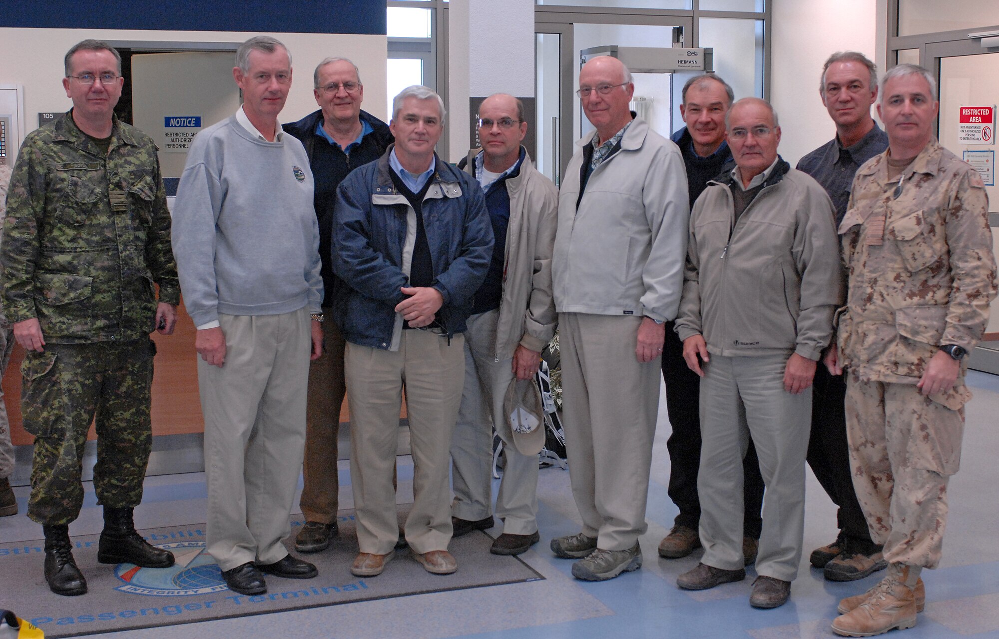 SPANGDAHLEM AIR BASE, Germany -- Members of the Canadian Conference of Defence Associations group pass through the 726th Air Mobility Squadron’s passenger terminal here Oct. 23. The group returned from Afghanistan after a five-day trip to visit Canadian soldiers participating in Operation Enduring Freedom. From left to right: Lt. Col. Damien Boyles, retired Lt. Gen. George Macdonald, retired Col. Alain-Michel Pellerin, Tom Caldwell, retired Lt. Col. Remy Landry, retired Gen. Paul Manson, former Chief of Defence Staff, retired Lt. Col. Gilles Paradis, retired Rear Adm. Ken Summers, Clarence Roussel and Col. Richard Gigoere. (U.S. Air Force photo/Airman 1st Class Nathanael Callon)