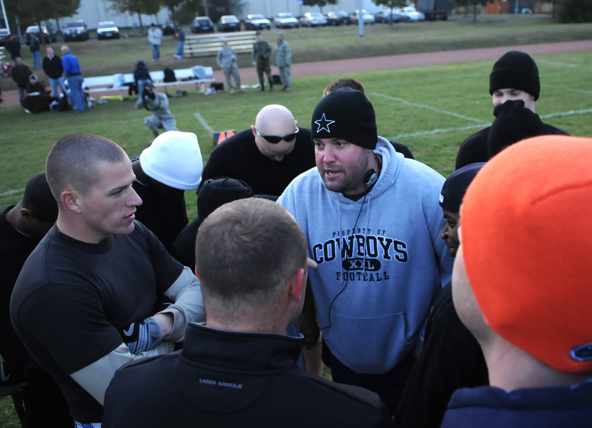 Team Comm coach Robert Latimer (center) motivates his players before the Army versus Air Force flag football game, Vogelweh Military Complex, Germany, Oct. 21, 2009. The Air Force team beat the Army, represented by Team Landstuhl Regional Medical Center, with a final score of 12-7. (U.S. Air Force photo by Tech. Sgt. Sean White)