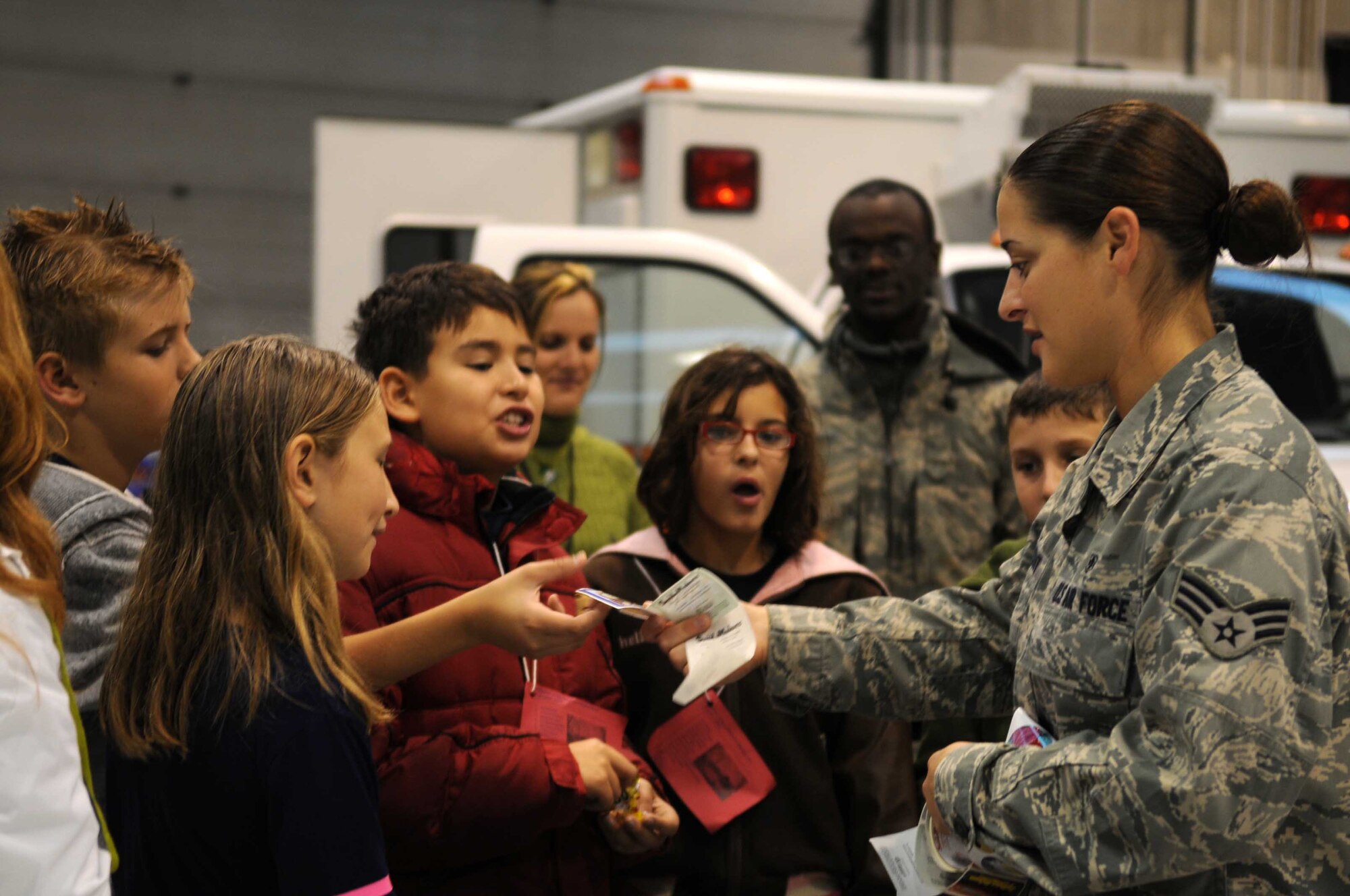 Senior Airman Lindsey Vincent, 603rd Air Control Squadron, briefs a group of Aviano Elementary School fifth graders on the importance of public health issues related to a deployment to include the use of Deet, hand washing and dangers within the local vicinity during the Aviano Kids Deployment Day Oct. 22, 2009 at Aviano Air Base, Italy. During the event, students tasted Meals Ready to Eat and tried on personal protective equipment to get a better understanding of what their parents go through downrange.
 (U.S. Air Force photo/Senior Airman Nadine Barclay)
