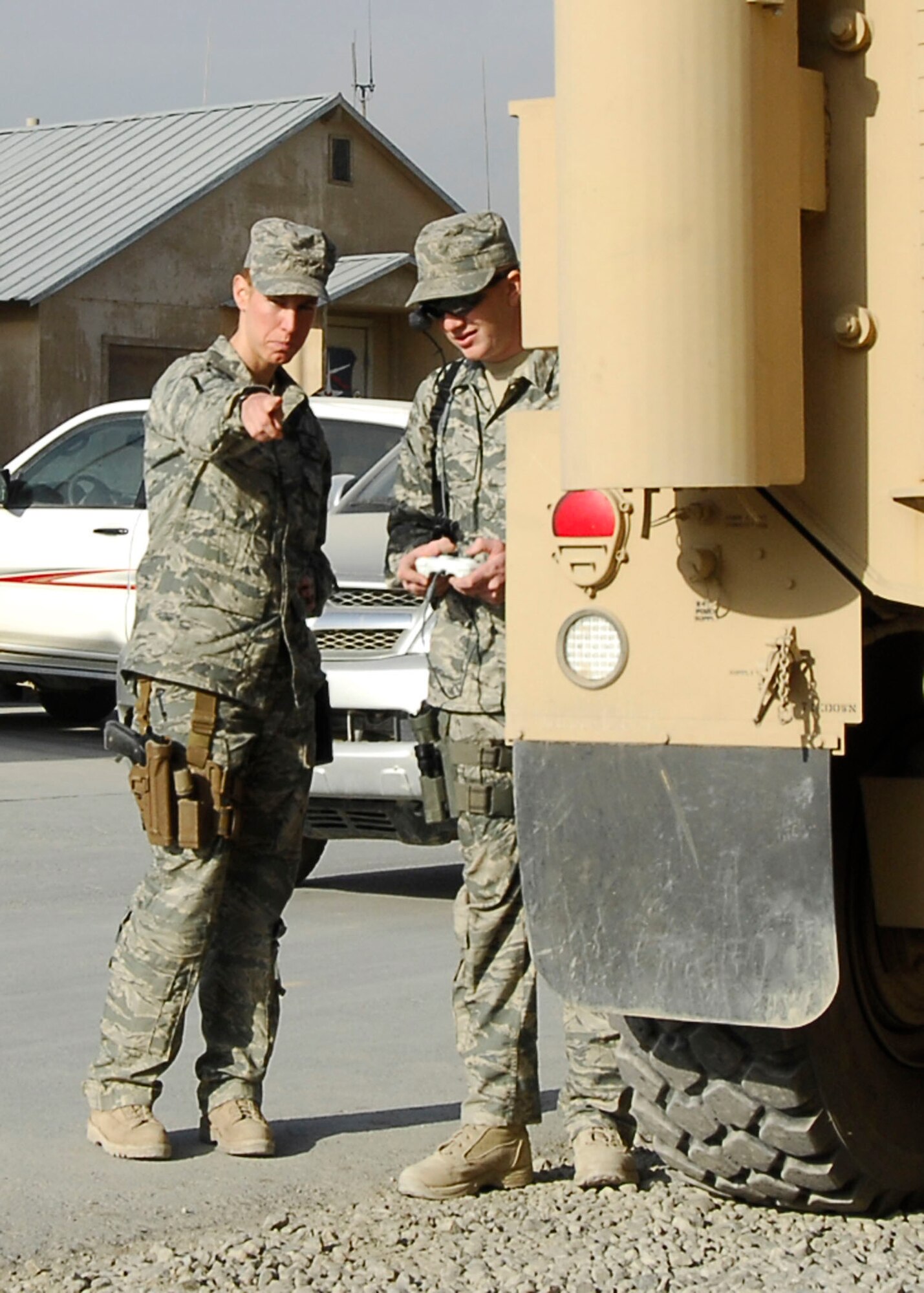 BAGRAM AIRFIELD, Afghanistan -- Staff Sgt. Elizabeth Spradley (left) gives directions to Senior Airman James Dobrynski (right), both explosives ordnance disposal technicians, during training Oct. 26, 2009.  EOD uses robots during missions to move or disarm IEDs and look for additional IEDs.  The EOD Airmen are Joint Expeditionary Tasked Airmen from the 755th Air Expeditionary Group, 755th EOD Alpha Flight, attached to the 741st EOD Battalion.  Sergeant Spradley, an Albuquerque, N.M. native, is deployed from Spangdahlem Air Base, Germany.  Airman Dobrynski is deployed from Luke Air Force Base, Ariz., and hails from St. Louis, Mo.  (U.S. Air Force photo/Senior Airman Felicia Juenke)