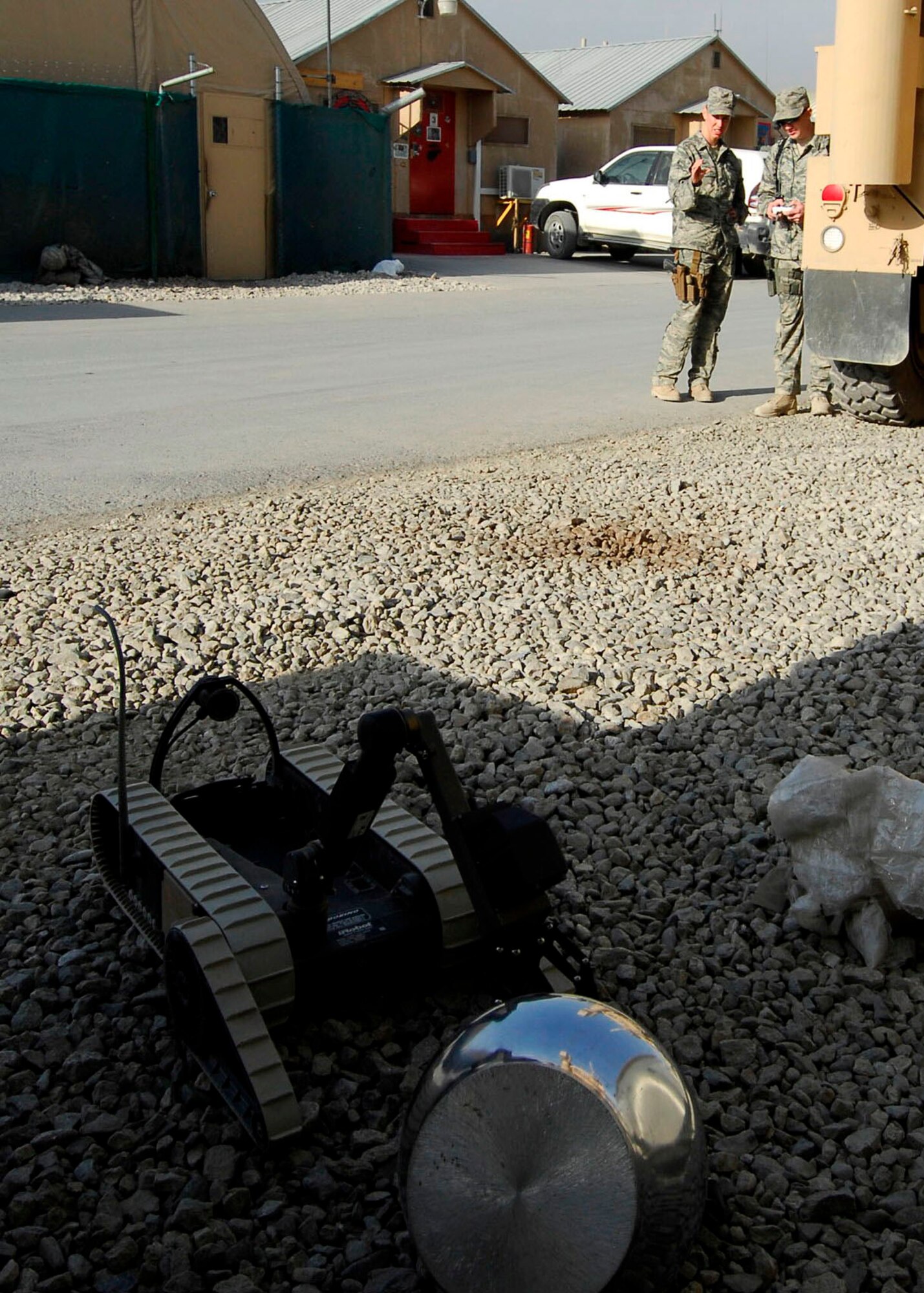 BAGRAM AIRFIELD, Afghanistan -- Staff Sgt. Elizabeth Spradley (left) and Senior Airman James Dobrynski (right), both explosives ordnance disposal technicians, work together to have a robot pick up a mock Improvised Explosive Device during training Oct. 26, 2009.  The EOD Airmen are Joint Expeditionary Tasked Airmen from the 755th Air Expeditionary Group, 755th EOD Alpha Flight, attached to the 741st EOD Battalion.  Sergeant Spradley, an Albuquerque, N.M. native, is deployed from Spangdahlem Air Base, Germany.  Airman Dobrynski is deployed from Luke Air Force Base, Ariz., and hails from St. Louis, Mo.  (U.S. Air Force photo/Senior Airman Felicia Juenke)