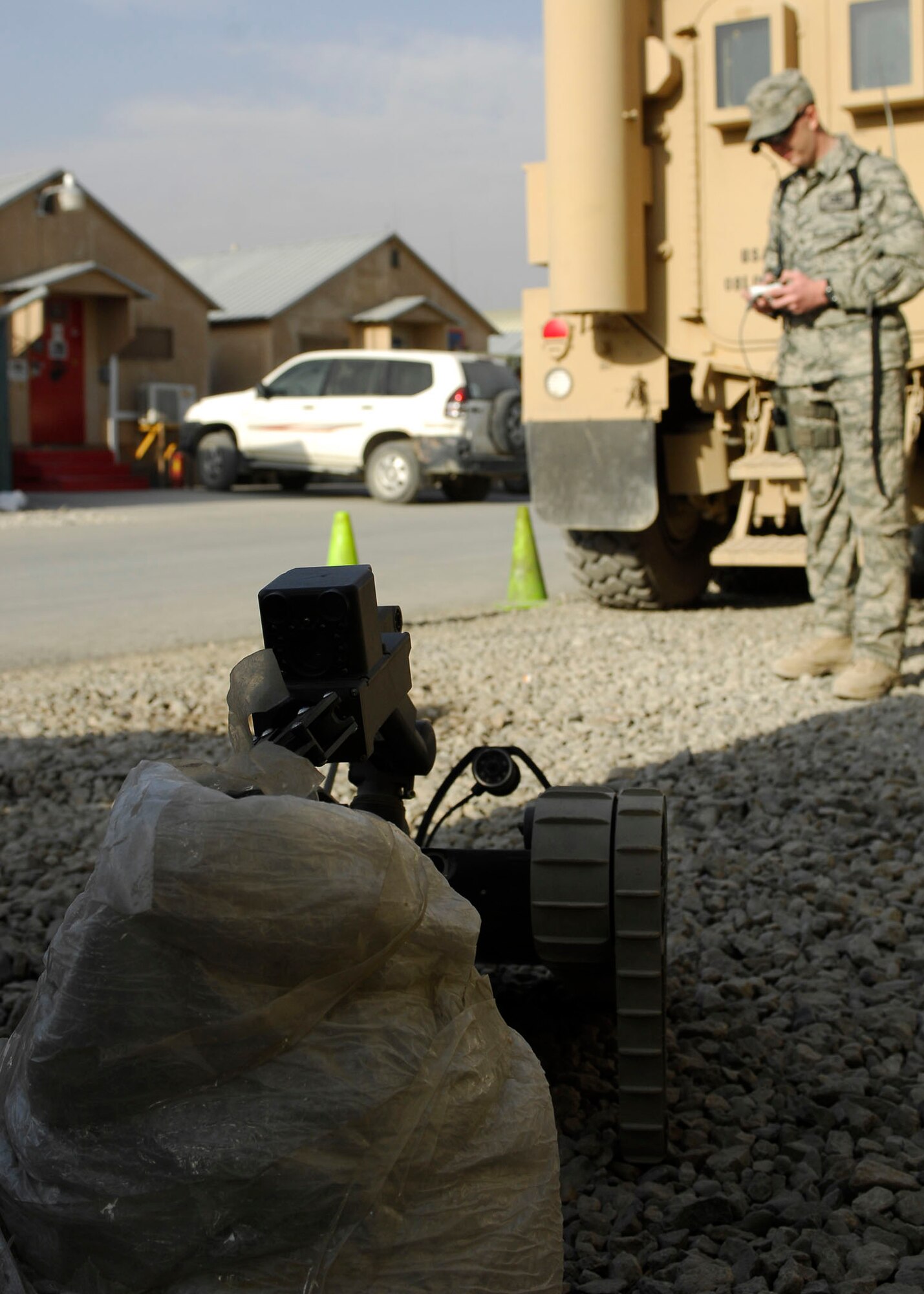 BAGRAM AIRFIELD, Afghanistan -- Senior Airman James Dobrynski, an explosives ordnance disposal technician, maneuvers a robot during training Oct. 26, 2009.  The robot is being used to remove plastic around a mock Improvised Explosive Device.   Airman Dobrynski is a Joint Expeditionary Tasked Airman from the 755th Air Expeditionary Group, 755th EOD Alpha Flight, attached to the 741st EOD Battalion.  Airman Dobrynski is deployed from Luke Air Force Base, Ariz., and hails from St. Louis, Mo.  (U.S. Air Force photo/Senior Airman Felicia Juenke)