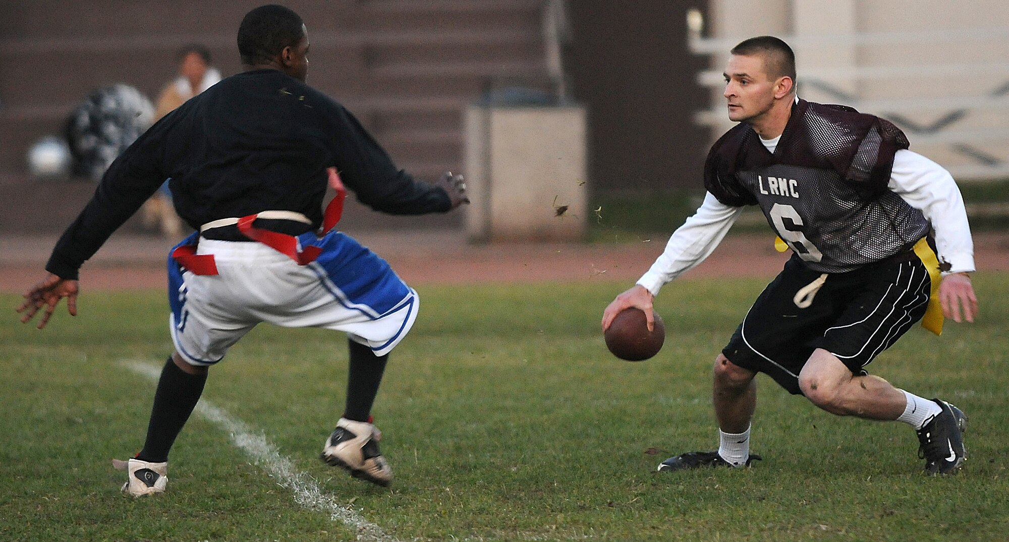 Team Landstuhl Regional Medical Center quarterback Robert Dawson scrambles while under pressure during the Air Force versus Army flag football game, Vogelweh Military Complex, Germany, Oct. 21, 2009. The Air Force team, represented by the 86th Communications Squadron, beat the Army with a final score of 12-7. (U.S. Air Force photo by Senior Airman Nathan Lipscomb)