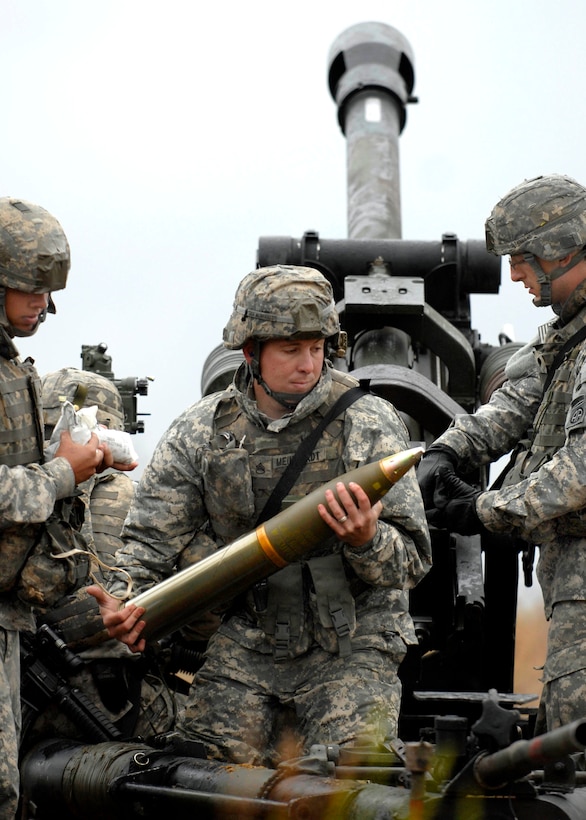 U.S. Army Staff Sgt. Eric Meinhardt loads a round into the howitzer to fire during a training exercise on Fort Bragg, N.C., Oct. 14, 2009. Meinhardt is a paratrooper assigned to the 82nd Airborne Division’s 2nd Battalion, 319th Airborne Field Artillery Regiment.