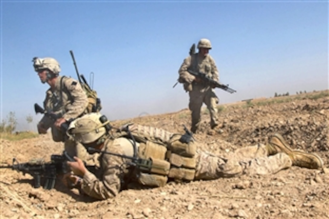 U.S. Marines prepare to move to a different fighting position after receiving fire during a security patrol through the Nawa district in Helmand province, Afghanistan, Oct. 15, 2009. The Marines, assigned to Bravo Company, 1st Battalion, 5th Marine Regiment, were conducting security patrols to decrease insurgent activity and gain the trust of the Afghan people.