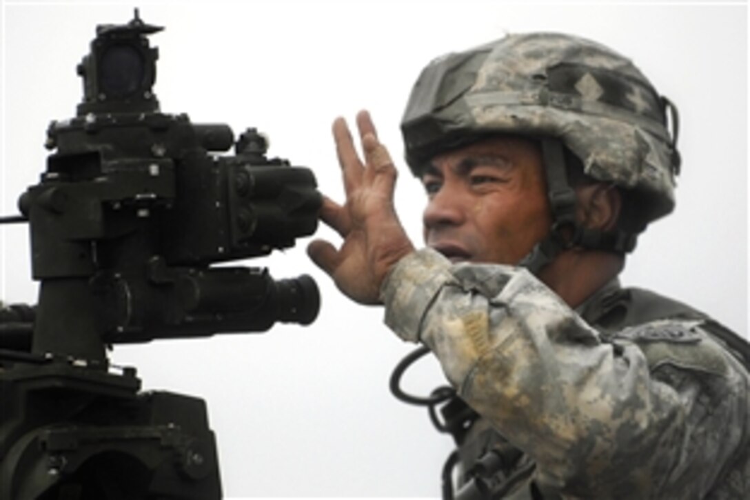 U.S. Army Sgt. Haseni Lave aims the howitzer to fire during a training exercise on Fort Bragg, N.C., Oct. 14, 2009. Lave is a paratrooper assigned to the 82nd Airborne Division’s 2nd Battalion, 319th Airborne Field Artillery Regiment.