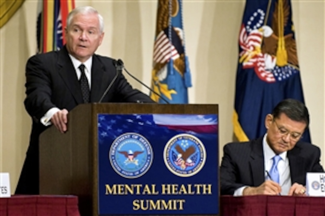 Defense Secretary Robert M. Gates addresses the audience as Veterans Affairs Secretary Eric K. Shinseki takes notes during the DOD/VA Mental Health Summit in Washington, D.C., Oct. 26, 2009.  The summit was the first of its kind and featured mental health experts from both departments, other cabinet agencies and nongovernmental organizations. The goal was to discuss a public health model for enhanced mental health care for returning troops, veterans and their families.  