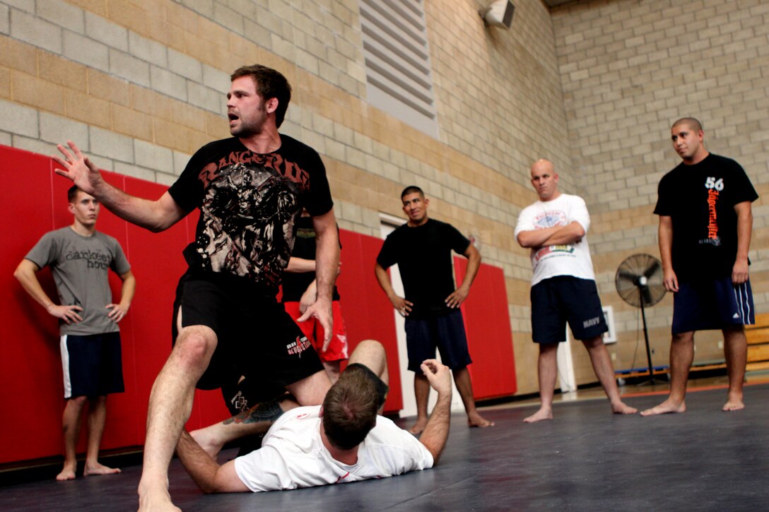Tim Credeur, mixed martial arts instructor and fighter, explains the proper procedures for handling a down opponent during a special MMA clinic for Camp Pendleton Marines at Paige Fieldhouse, Oct. 26.