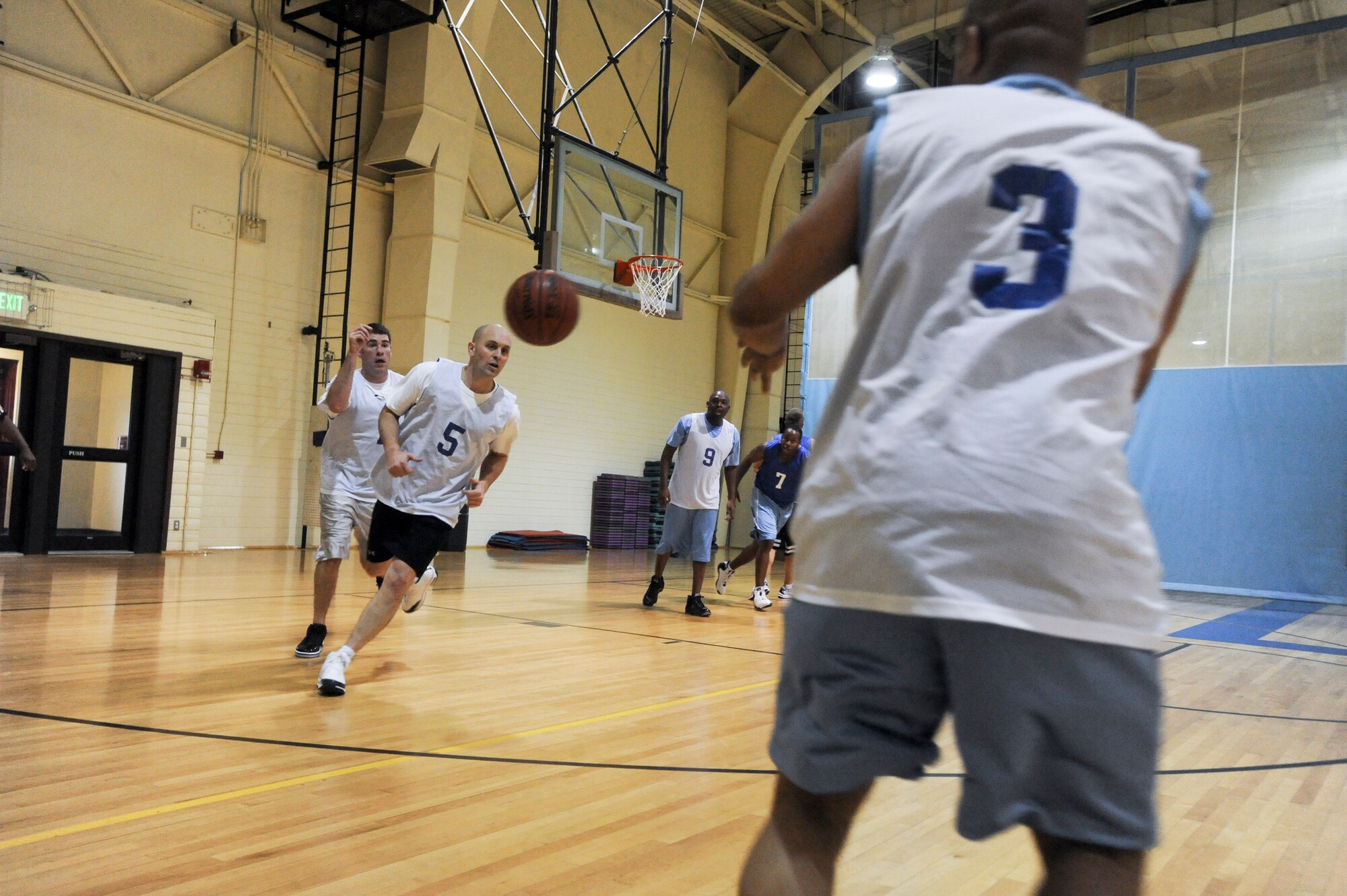 ELMENDORF AIR FORCE BASE, Alaska -- Members of the 3rd Equipment Maintenance Squadron move the ball down the court during their Oct. 26 game against the 3rd Force Support Squadron. The 3rd EMS won the came in overtime with a score of 49-47. (U.S. Air Force photo/ Airman Jack Sanders)
