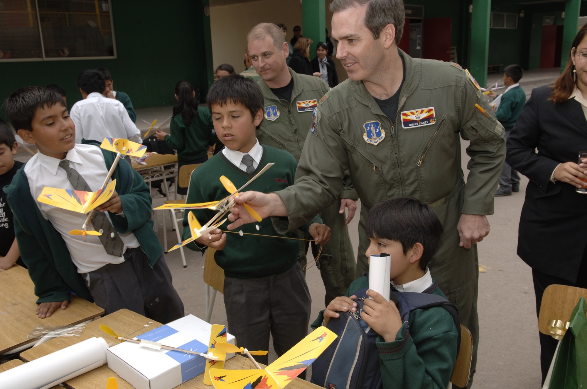 IQUIQUE, Chile -- Maj. Quinn Casey, 161st Air Refueling Wing pilot, helps sixth-grade students of Colegio Macaya in Alto Hospicia, Chile, construct model airplanes during a joint U.S.-Fuerza Aerea de Chile visit to the school Oct 27.  (U.S. Air Force photo by Tech. Sgt. Eric Petosky)