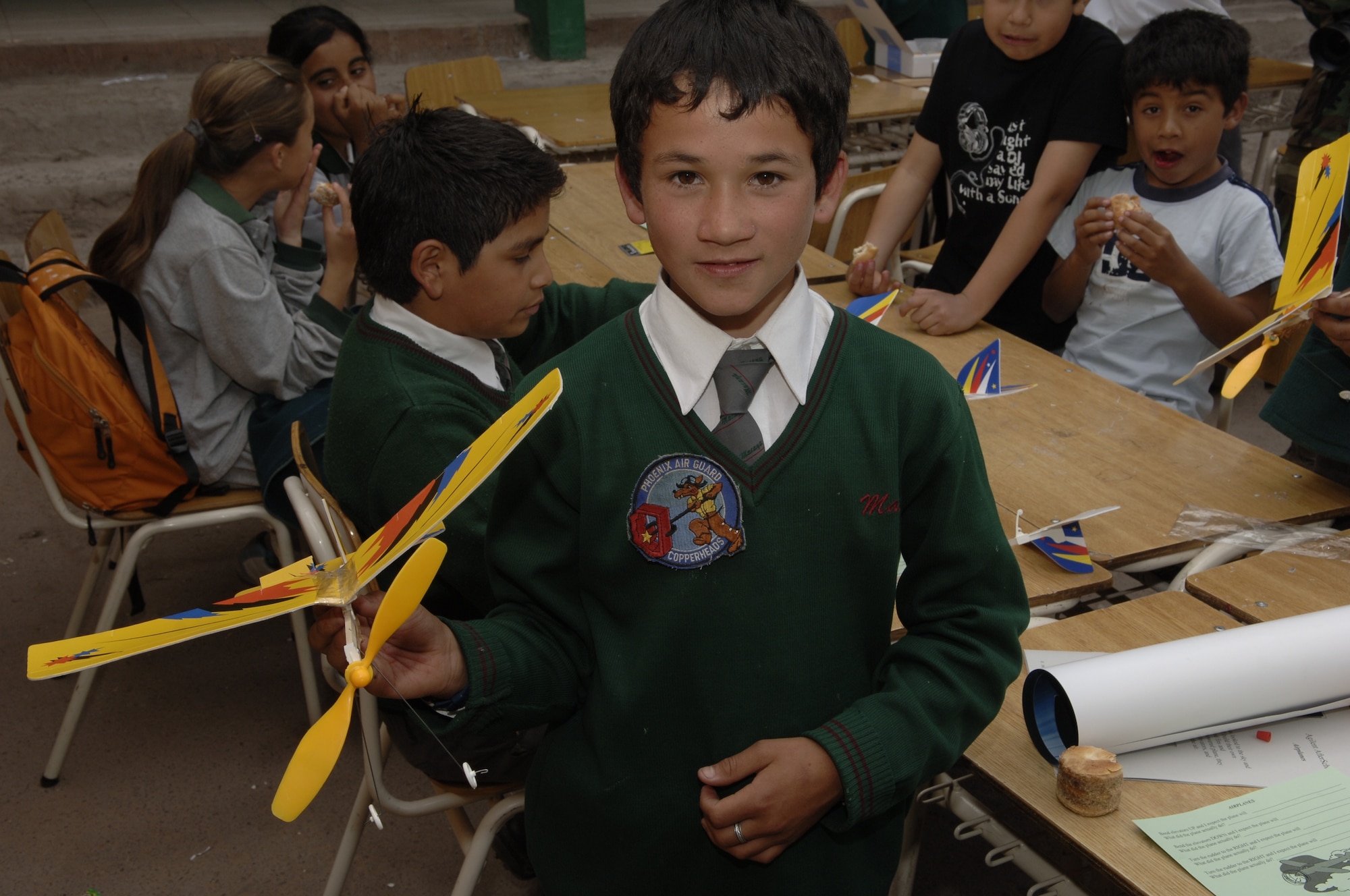 IQUIQUE, Chile -- A sixth-grade student of Colegio Macaya in Alto Hospicia, Chile, proudly displays his completed model airplane and a 161st Air Refueling Wing patch during a joint U.S.-Fuerza Aerea de Chile visit to the school Oct 27.  (U.S. Air Force photo by Tech. Sgt. Eric Petosky)