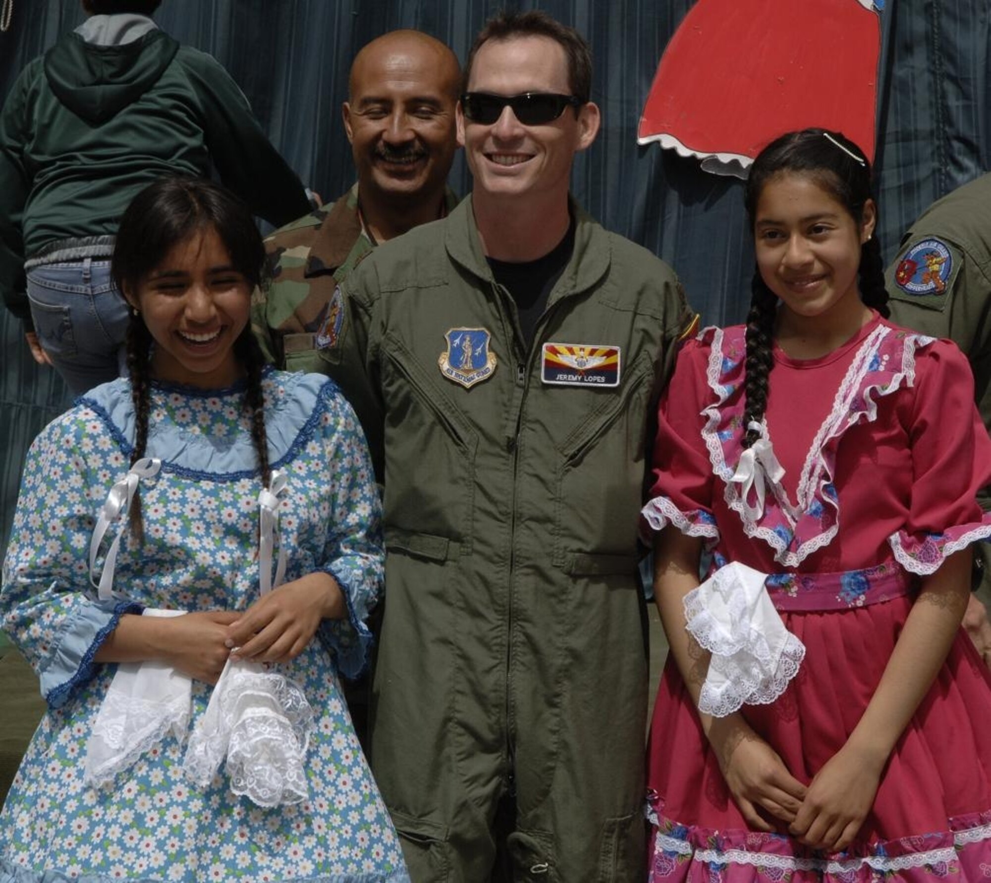 IQUIQUE, Chile -- Maj. Jeremy Lopes (middle right) and Tech. Sgt. Johnny Narro of the 161st Air Refueling Wing, pose for a photo with students of Colegio Macaya in Alto Hospicia, Chile.  (U.S. Air Force photo by Tech. Sgt. Eric Petosky)
