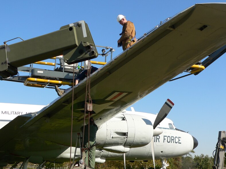 The C-118 Liftmaster restoration team at Joint Base McGuire-Dix-Lakehurst, N.J., prepares to remove the aircraft's wings on Oct. 20, 2009, at the joint base. The Liftmaster will be relocated to a nearby hangar, where it will undergo a major restoration over the next 10 months. According to Mr. Gary Boyd, 305th Air Mobility Wing historian, "The Liftmaster is integral to the history of the base. It made McGuire Air Force Base the gateway to the east." (U.S. Air Force Photo/Steve Snyder)