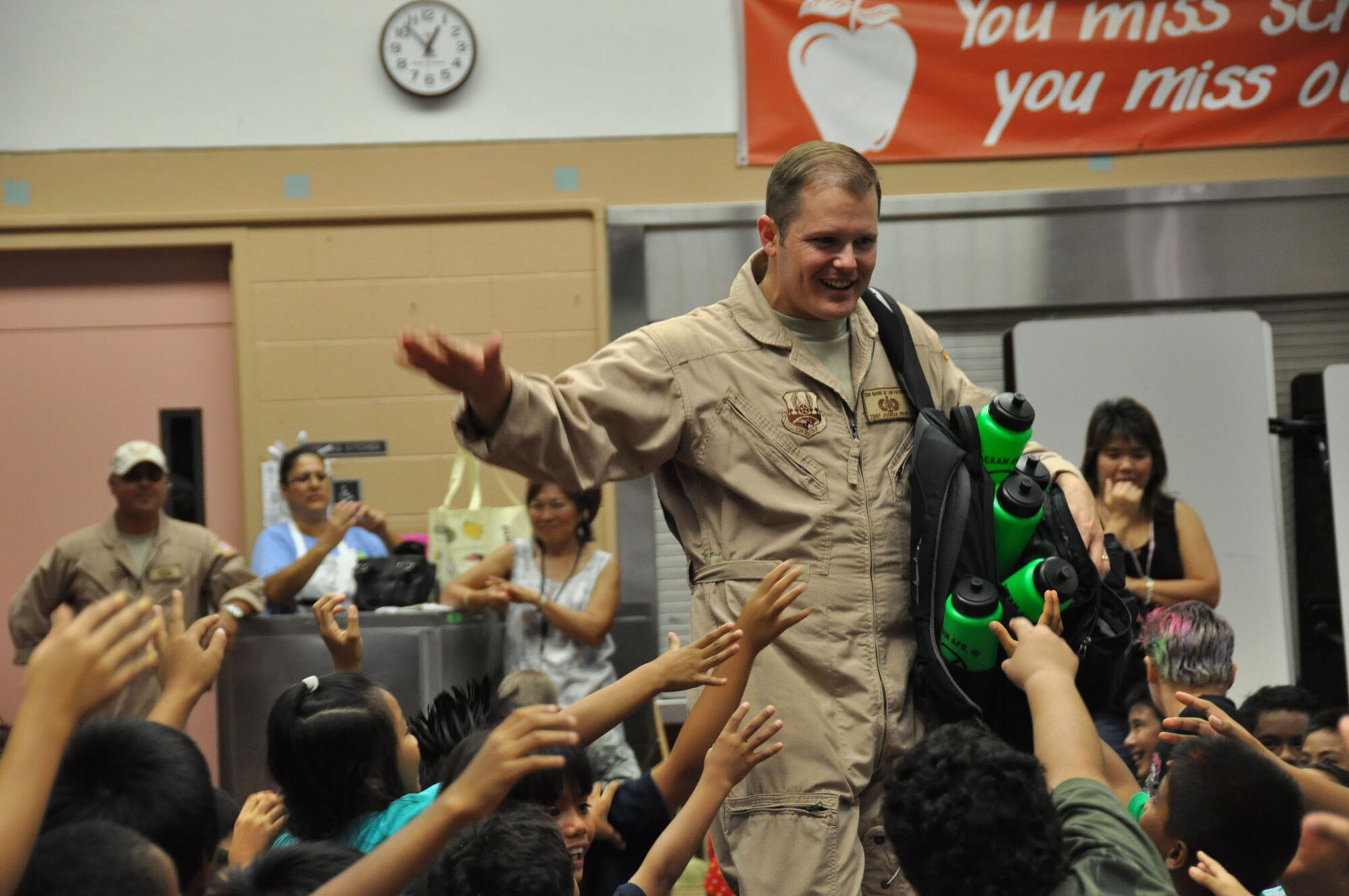 Tech. Sgt. Joshua Fedele, U.S. Air Force Band of the Pacific-Hawaii saxophone player, interacts with students at K Elementary School Oct. 22 in Waipahu, Hawaii. The band performed a series of six concerts for local elementary schools for Red Ribbon Week, a program aimed at reinforcing children's decisions to stay away from drugs and make positive decisions in life. (U.S.  Air Force photo/Tec.h Sgt. Cohen A. Young)