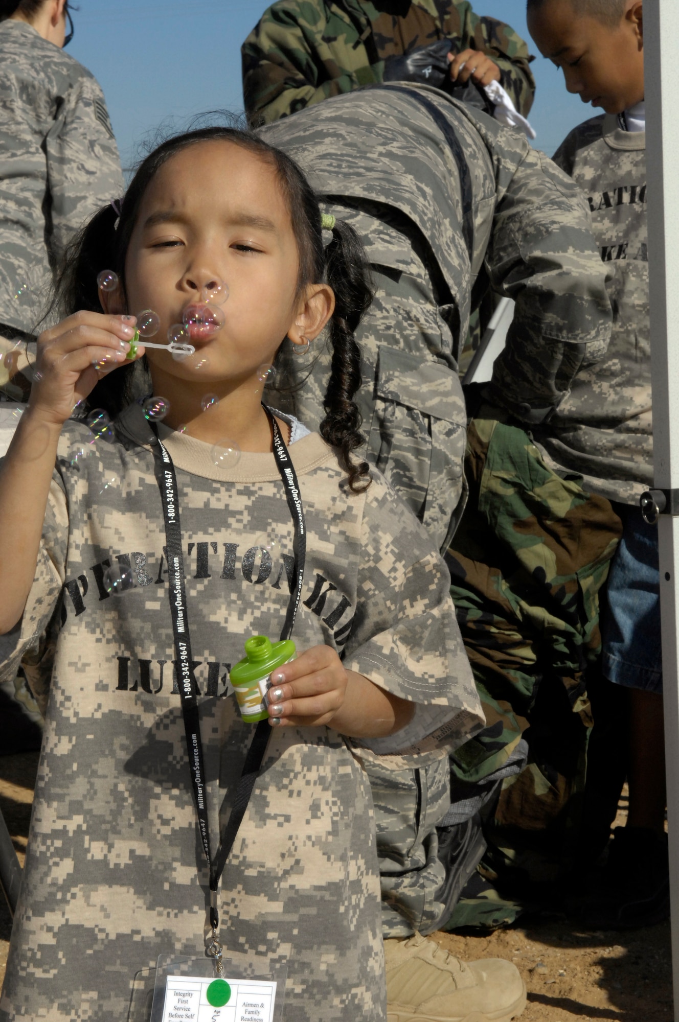 Veronika Brown, 5, takes time to relax and blow bubbles while "deployed" in support of the 2009 Operation Kids event, Oct. 24, 2009, Luke Air Force Base, Arizona. (U.S. Air Force Photo by Staff Sgt. Jason Colbert)