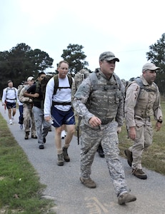 Senior Airman Johnathan Baxley, left, and Tech. Sgt. Raymond Pomeroy lead 437th Civil Engineer Squadron Explosive Ordnance Disposal Flight members on a ruck march here Oct. 27, joined by 437th Airlift Wing Commander Col. John Wood, 437th Mission Support Group Commander Col. Benjamin Wham and Chief Master Sgt. Mike Ivey, 437 AW command chief. The EOD members incorporate ruck marching into their physical training program to prepare for current operations in the Afghanistan theater. Airman Baxley is an EOD journeyman and Sergeant Pomeroy is the EOD superintendent, both are with the 437 CES. (U.S. Air Force photo/James Bowman)
