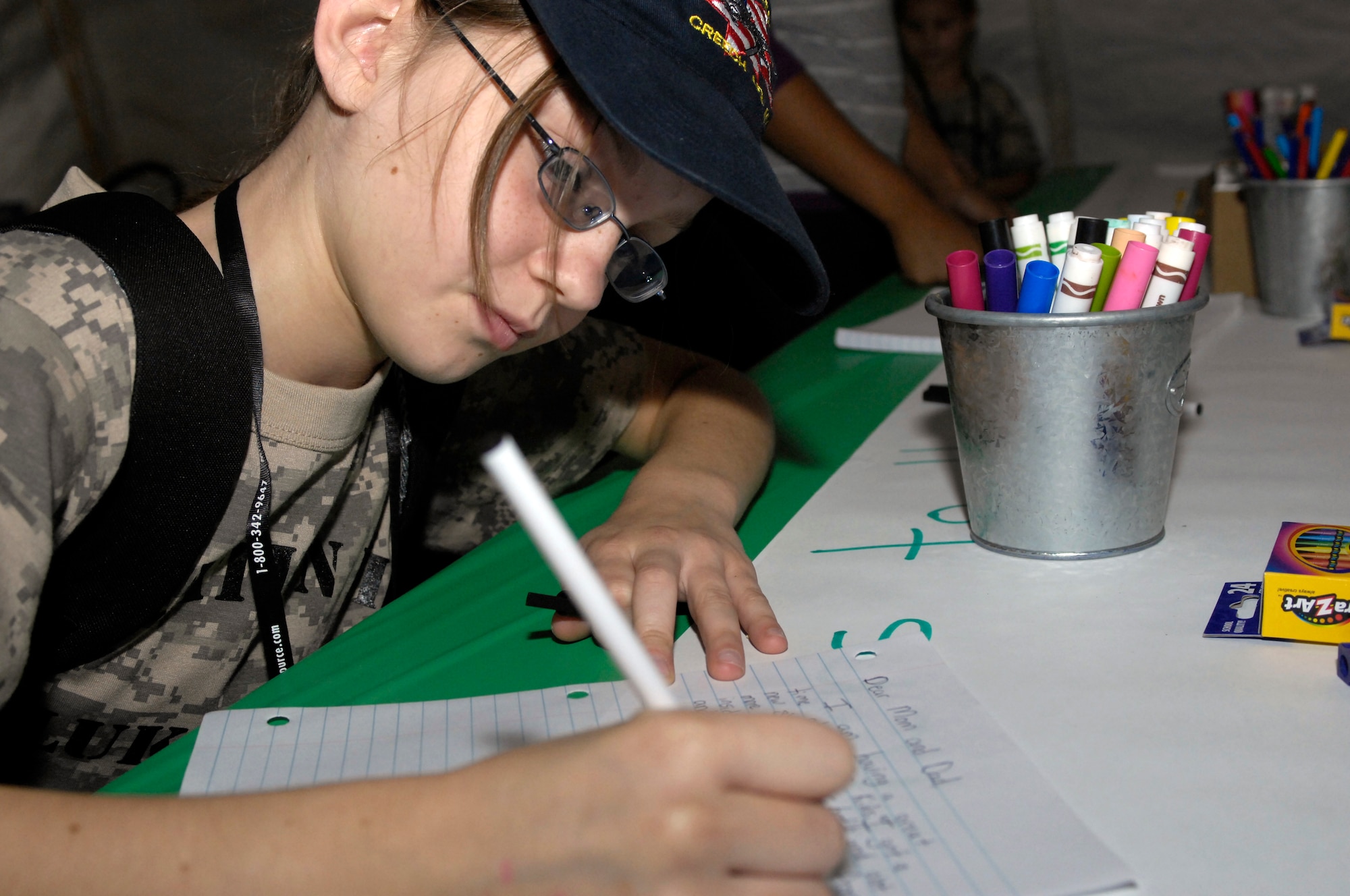 Christina Lehane, 11, writes a letter home while "deployed" in support of the 2009 Operation Kids event, Oct. 24, 2009, Luke Air Force Base, Arizona. (U.S. Air Force Photo by Staff Sgt. Jason Colbert)