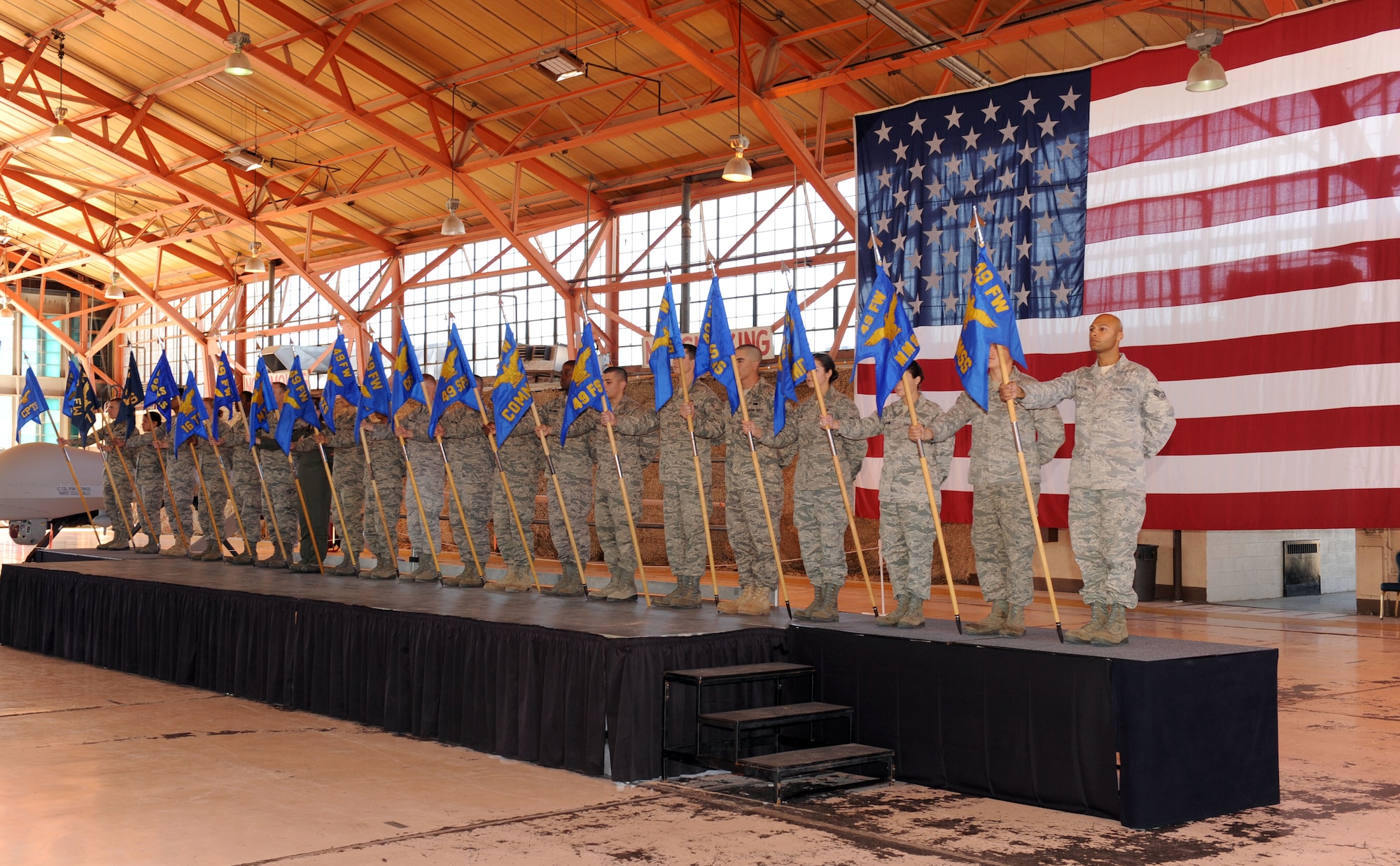 HOLLOMAN AIR FORCE BASE, N.M. -- Each unit assigned to the 49th Fighter Wing was represented by a guidon bearer during a 49th FW Roll Call here Oct. 23. The lineup of guidons signified the teamwork that went into the preparation for the wing's new roles and missions. (U.S. Air Force photo by Senior Airman Michael Means)